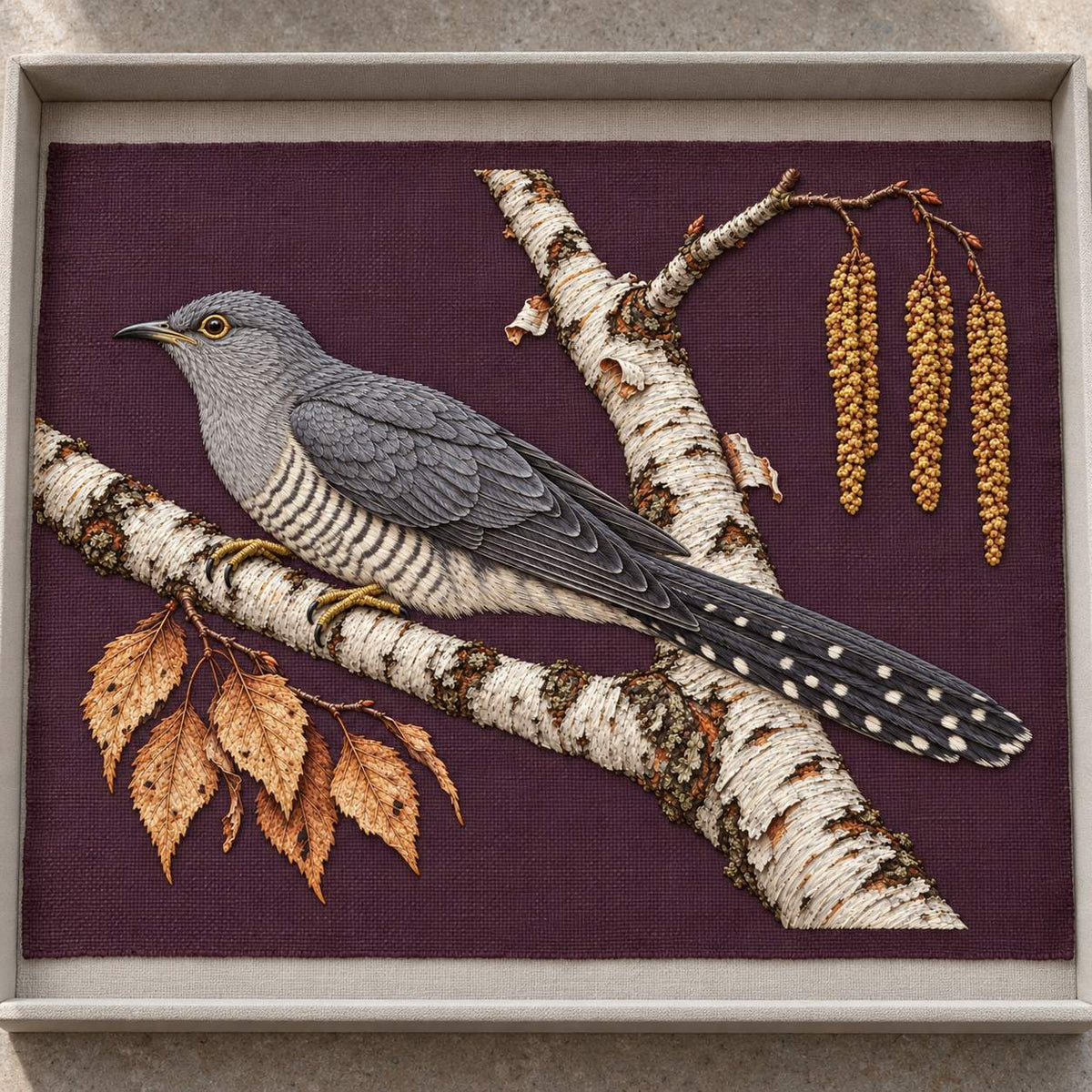 Cuckoo Beyond the Birch Fork visual mockup shown as a textile panel in a collection tray, with the design on burgundy linen.