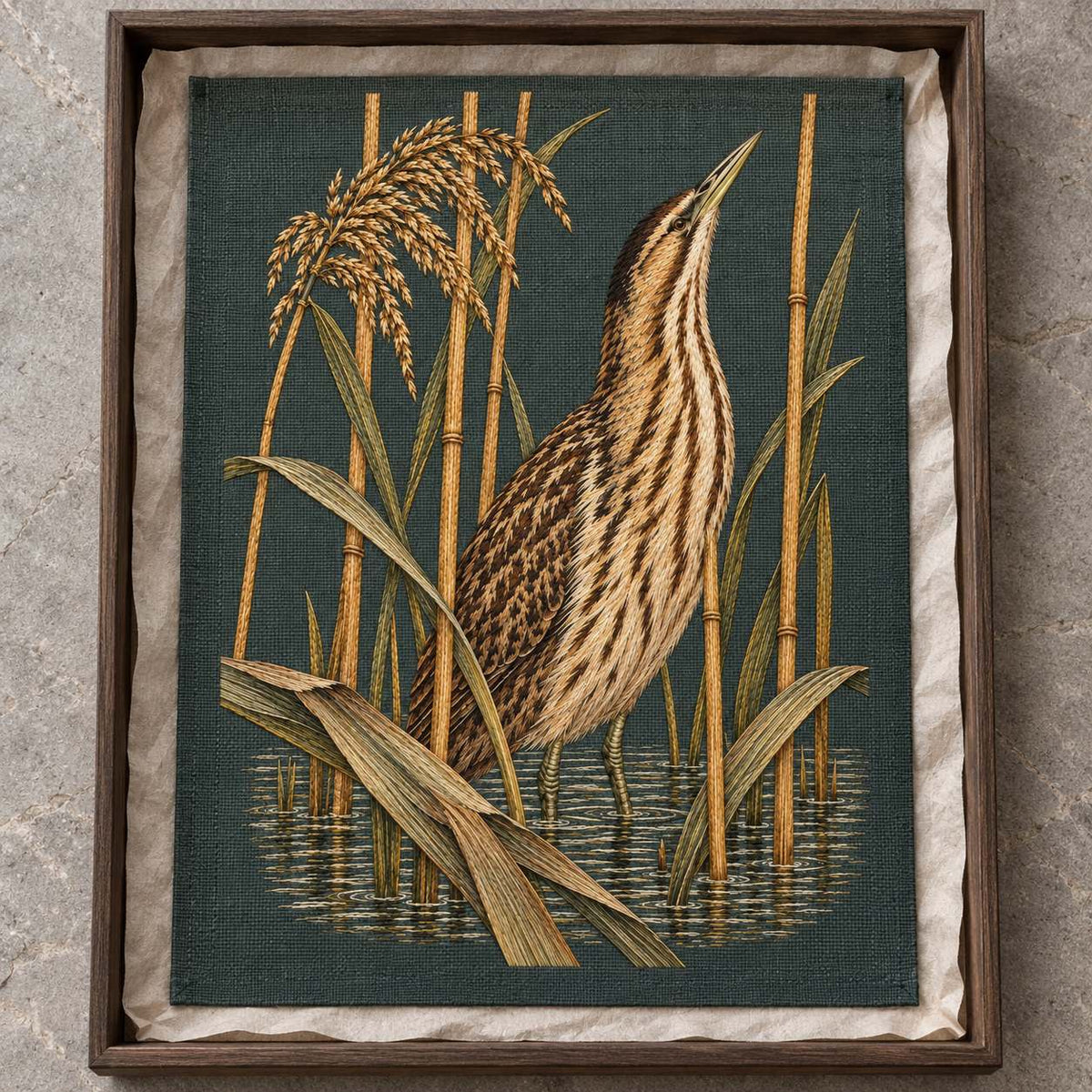 Bittern Behind the Ochre Reed Veil visual mockup shown as a textile panel in a collection tray, with the design on dark muted green linen.