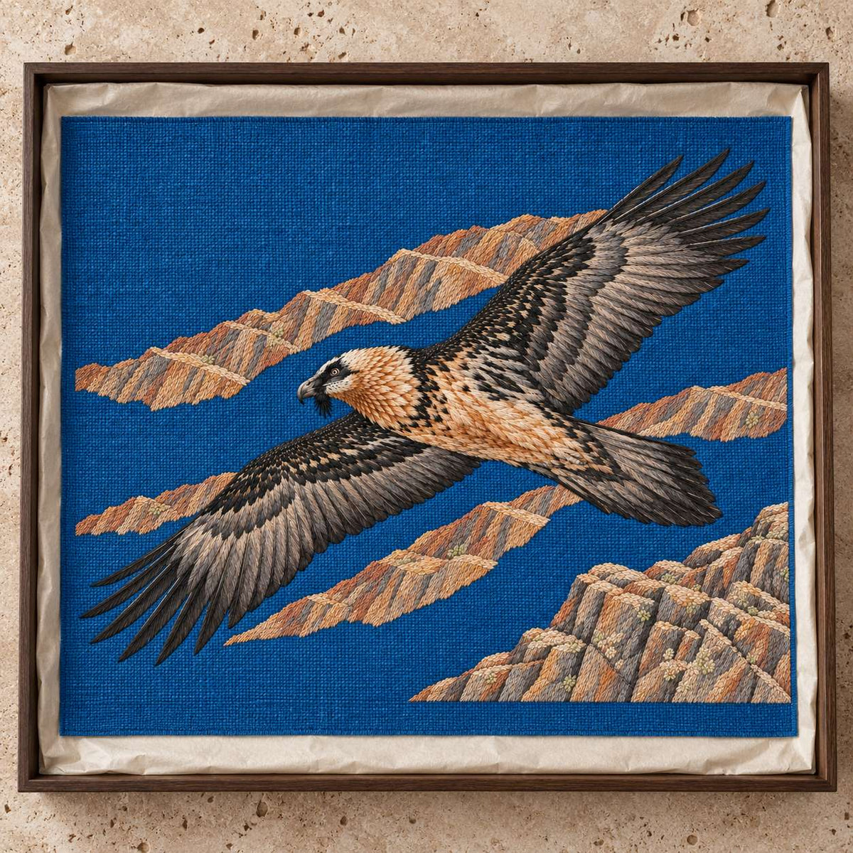 Lammergeier Through the Ochre Updraft visual mockup shown as a textile panel in a collection tray, with the design on deep blue linen.