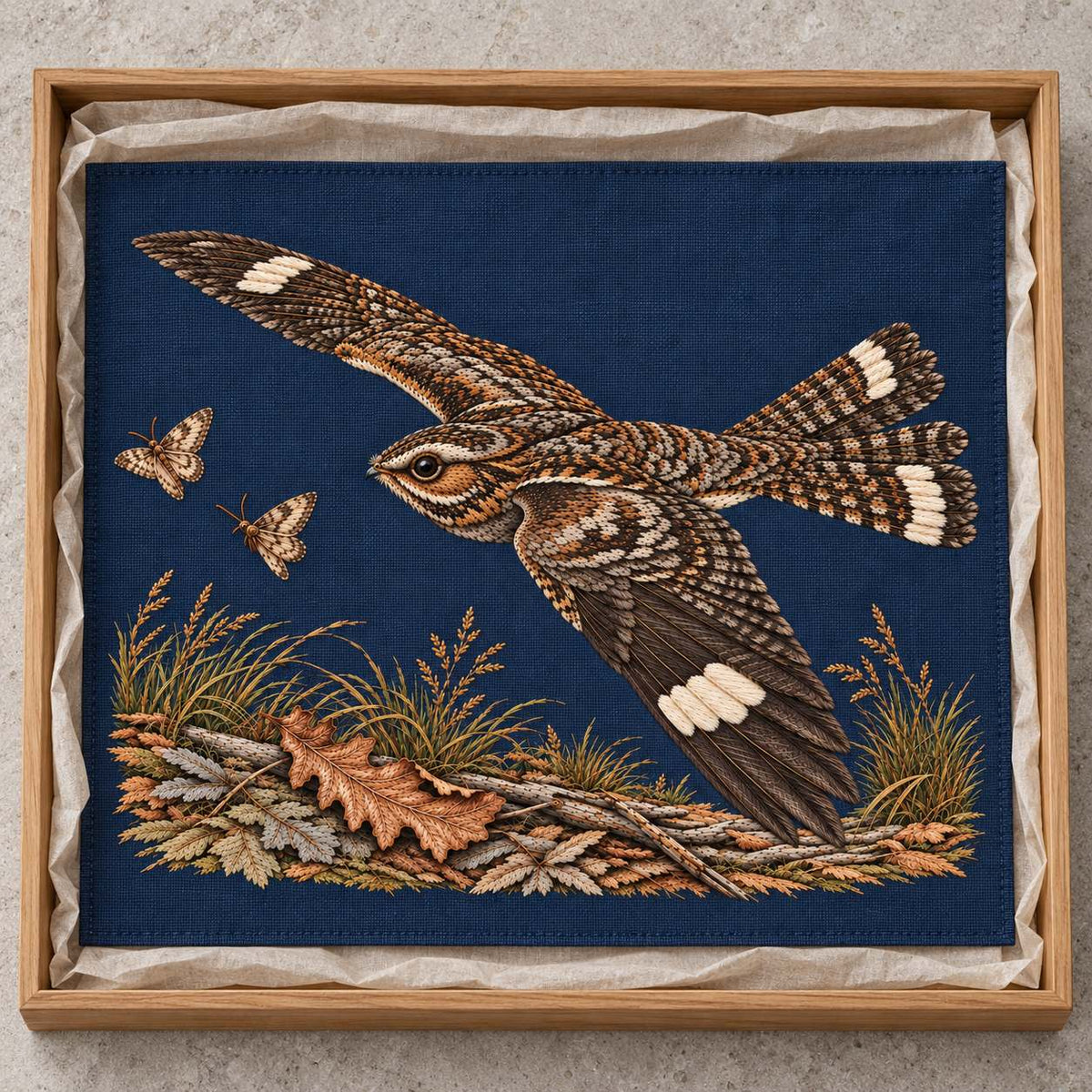Nightjar Across the Moth Dust Clearing visual mockup shown as a textile panel in a collection tray, with the design on deep midnight-blue linen.