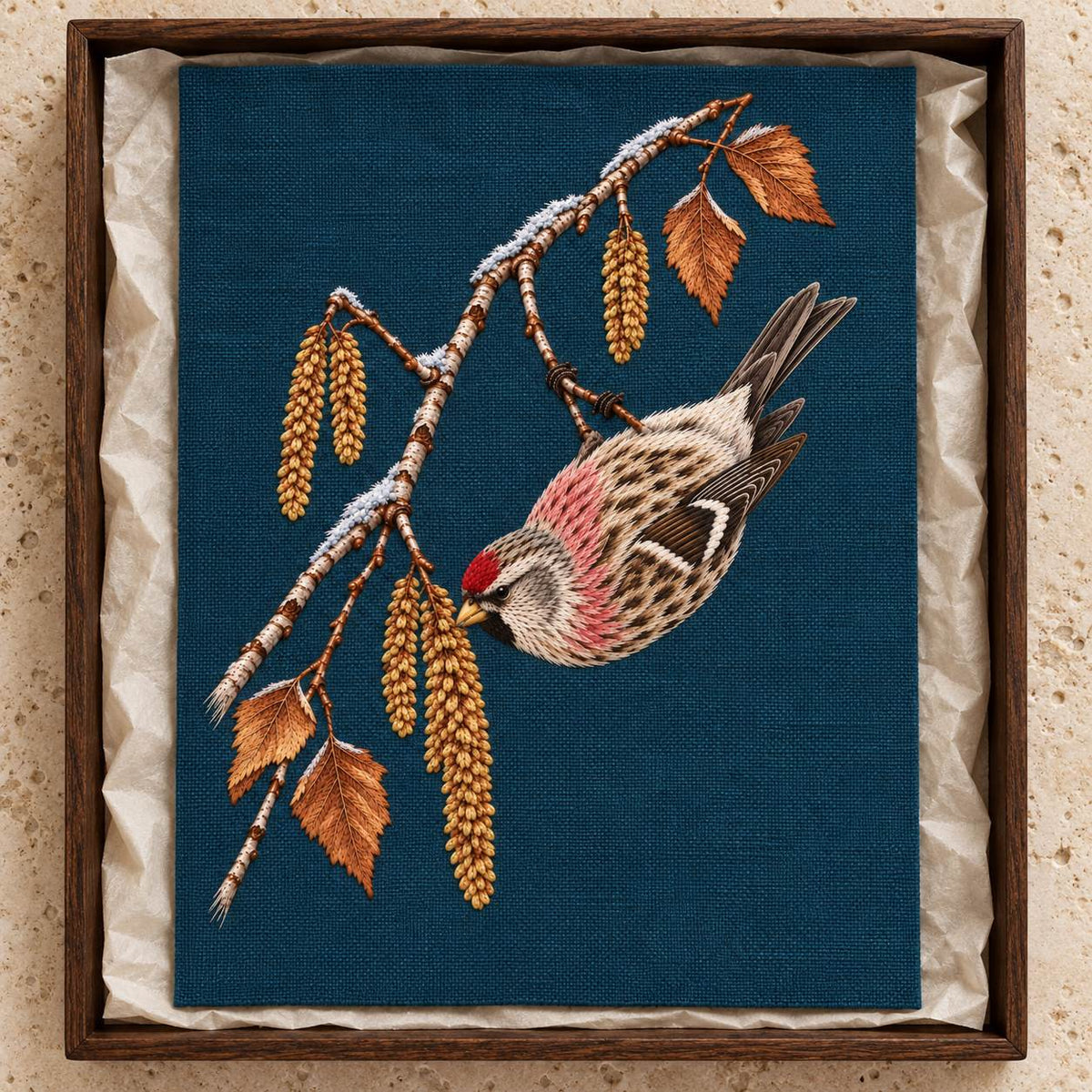 Redpoll Beneath the Birch Snow Tassel visual mockup shown as a textile panel in a collection tray, with the design on dark teal-blue linen.