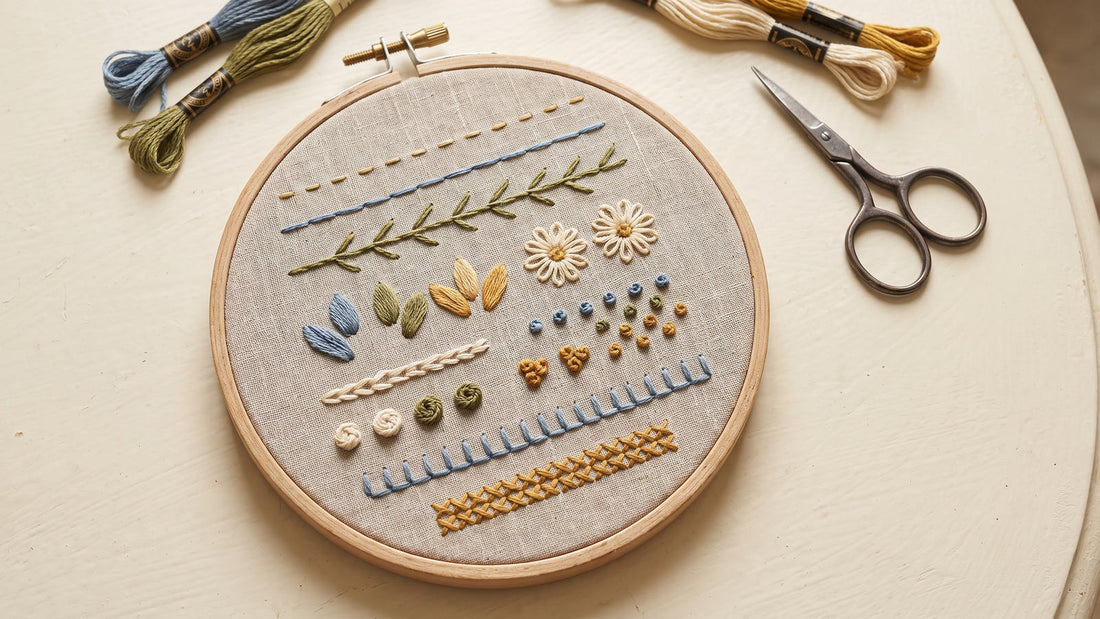 Hand embroidery sampler displaying nine basic stitches on natural linen