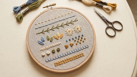 Hand embroidery sampler displaying nine basic stitches on natural linen