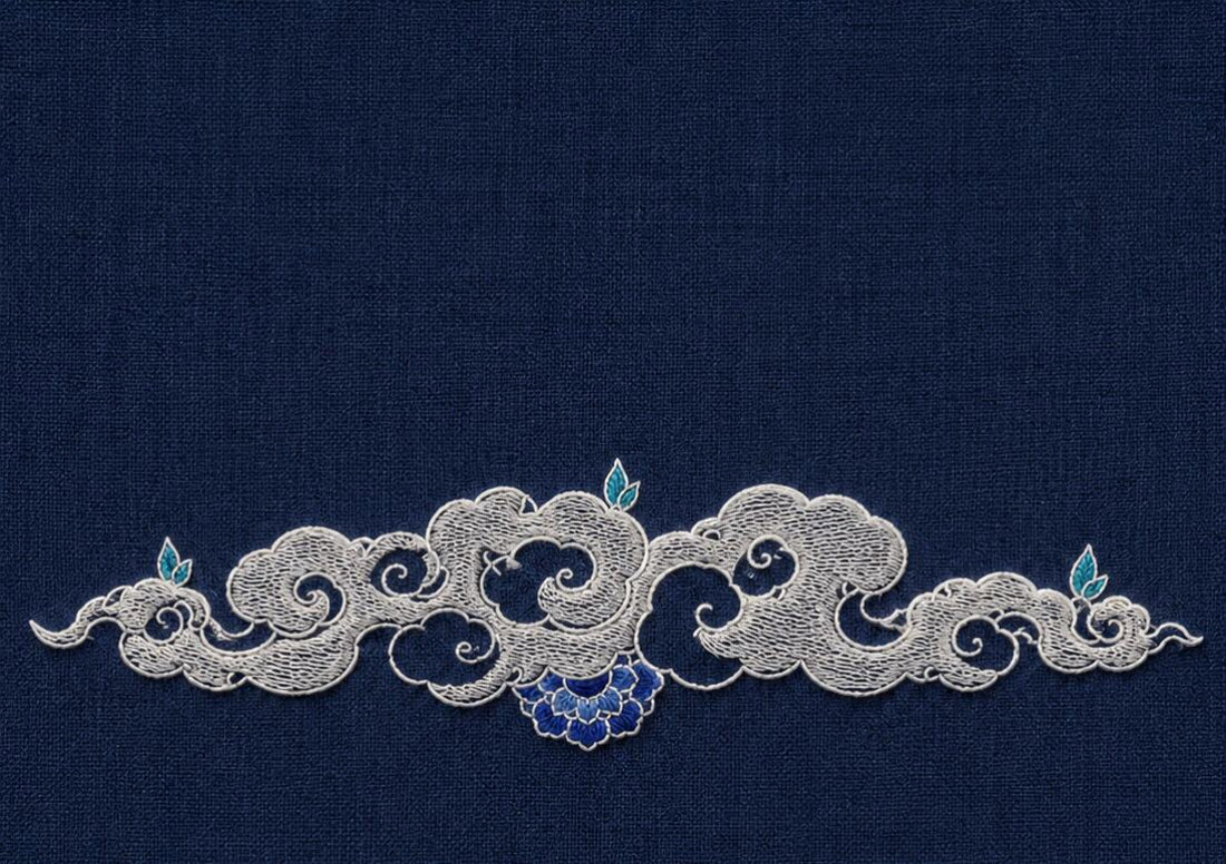 Silver-white Ottoman cloud band embroidered across midnight-blue linen