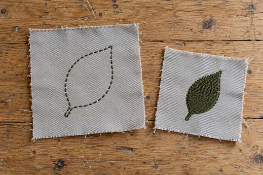Two pale grey fabric swatches with an open olive leaf outline and a filled olive leaf