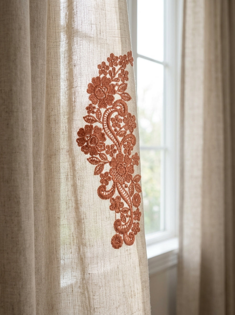 Cream pillow featuring an elegant blue floral and scroll border embroidered vertically along the fabric.