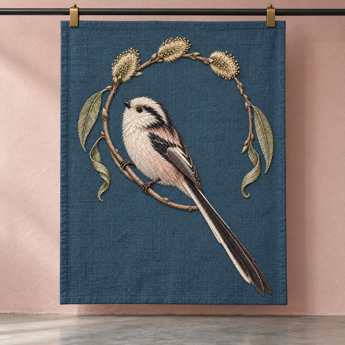 Long Tailed Tit in the Willow Loop visual mockup shown as a textile panel in a collection tray, with the design on dark slate-blue linen.