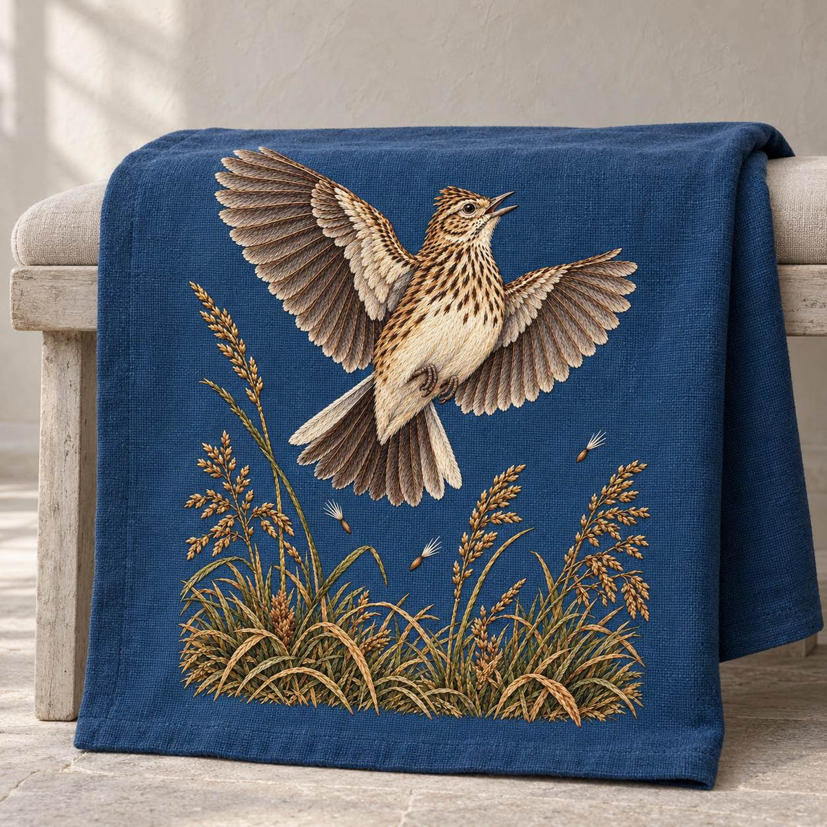 Skylark Above the Broken Seed Horizon visual mockup shown on a textile runner over a console, with the design on muted blue linen.
