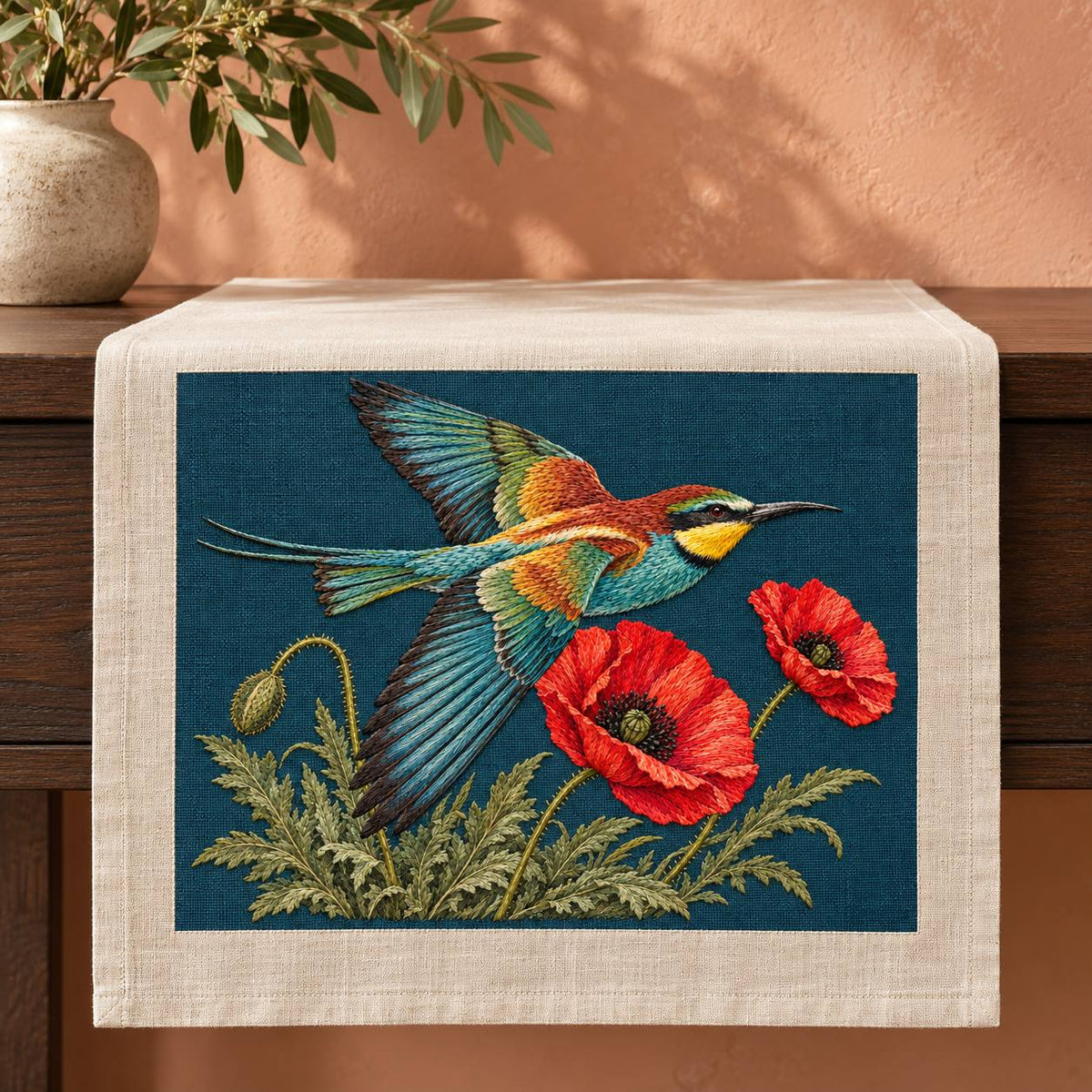 Bee Eater Crossing the Poppy Wind visual mockup shown on a textile runner over a console, with the design on dark teal linen.