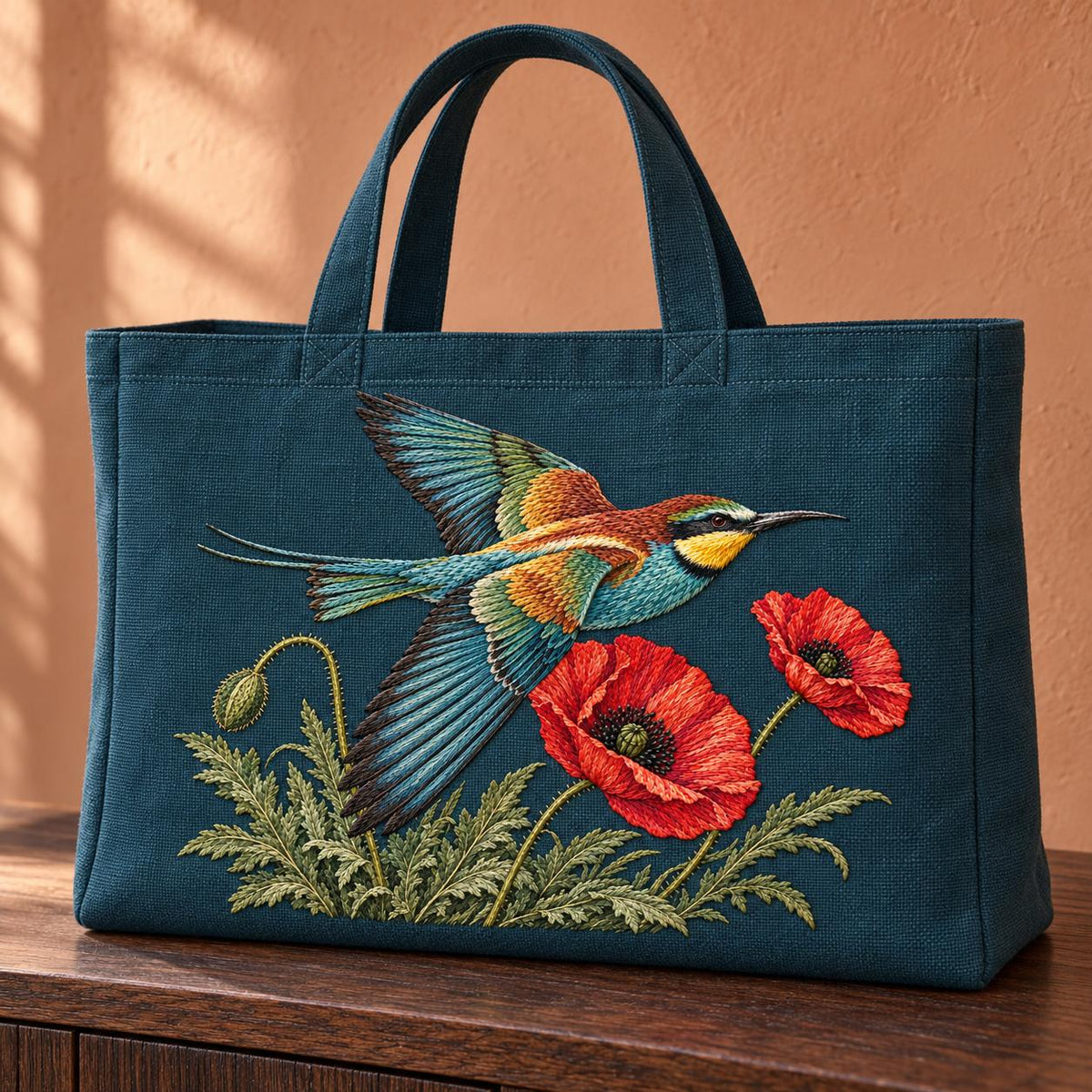 Bee Eater Crossing the Poppy Wind visual mockup shown on the front of a structured linen tote, with the design on dark teal linen.
