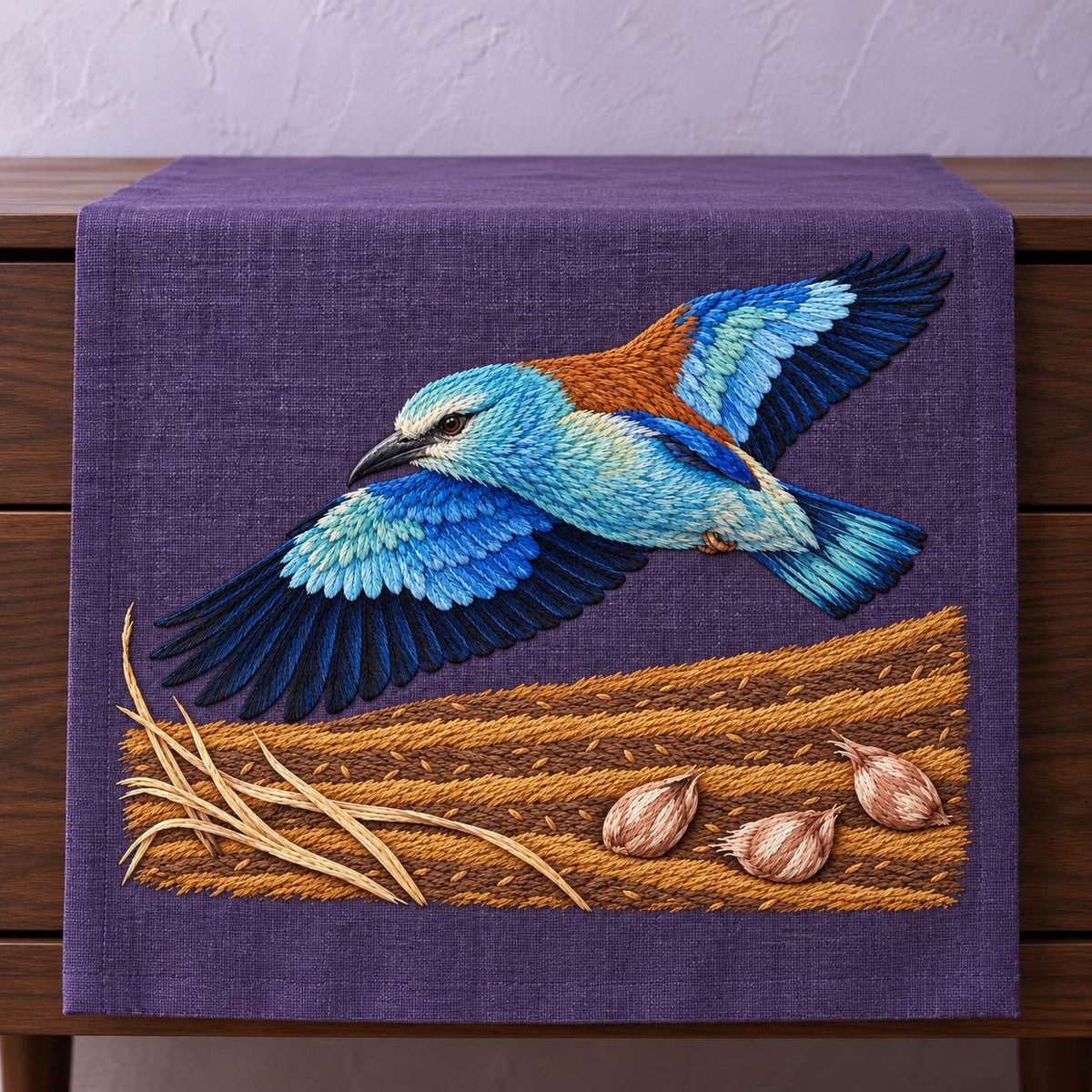 Roller Above the Saffron Field Break visual mockup shown on a textile runner over a console, with the design on plum linen.