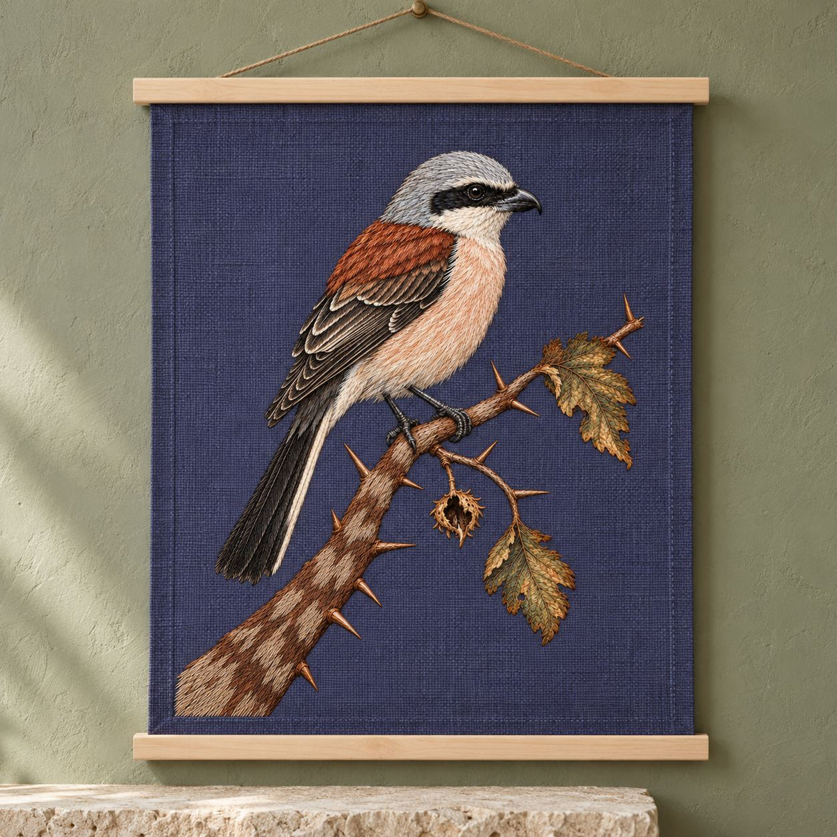 Shrike at the Thorned Boundary visual mockup shown as a hanging textile held by wooden rails, with the design on slate-plum linen.