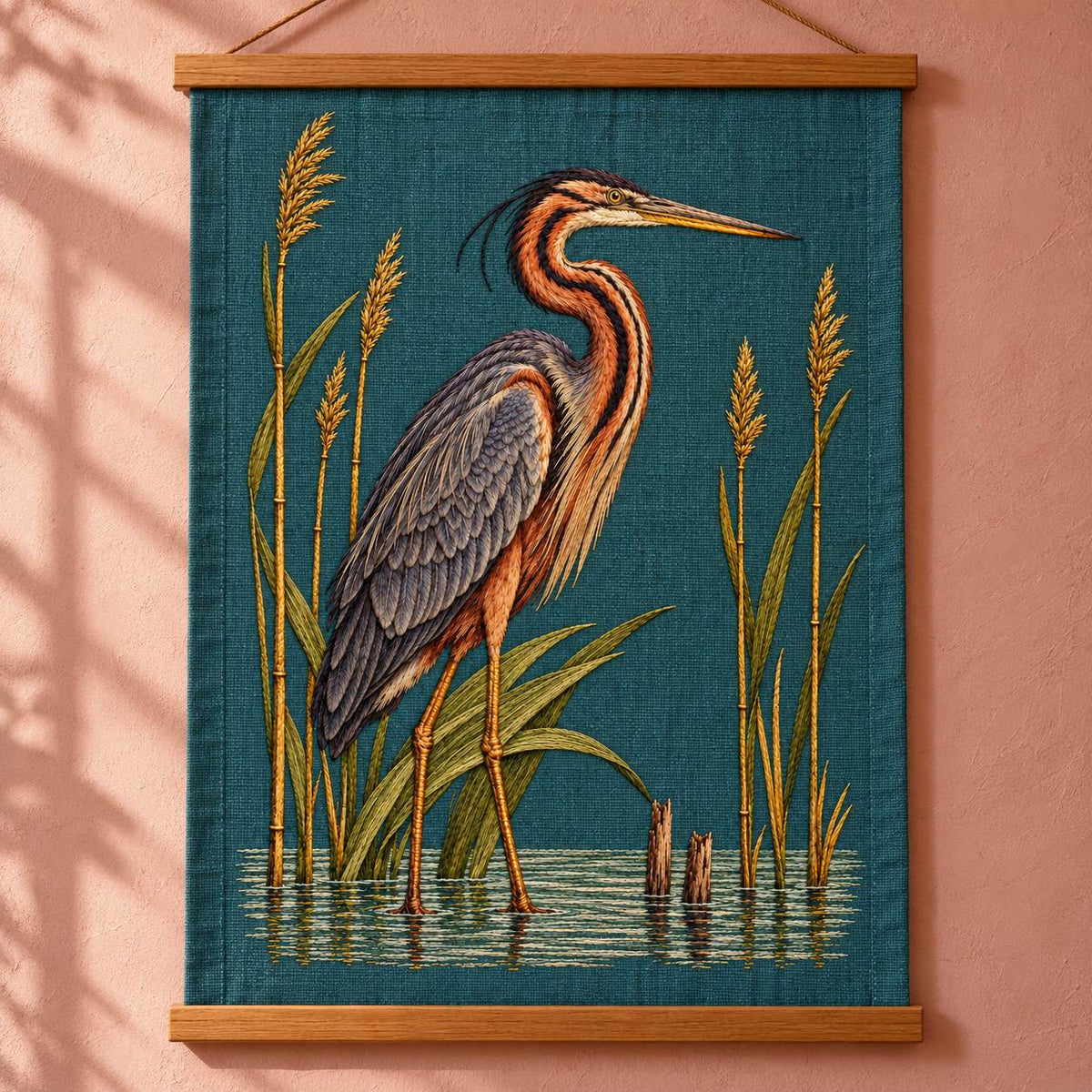 Purple Heron Inside the Reed Cathedral visual mockup shown as a hanging textile held by wooden rails, with the design on deep teal linen.