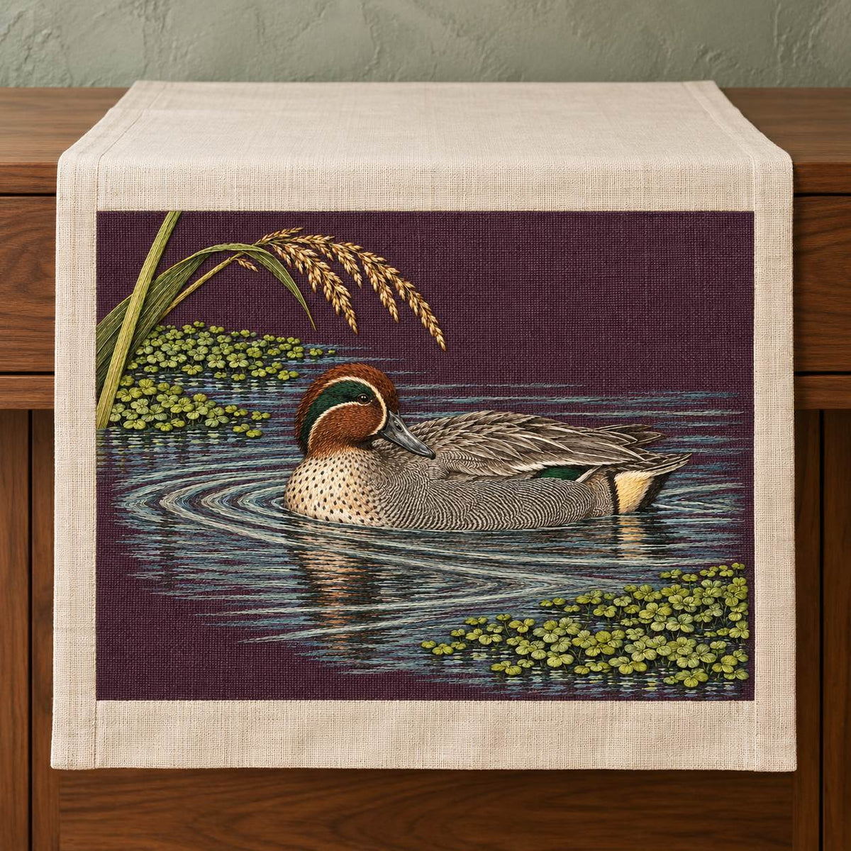 Teal at the Green Water Fold visual mockup shown on a textile runner over a console, with the design on deep plum linen.