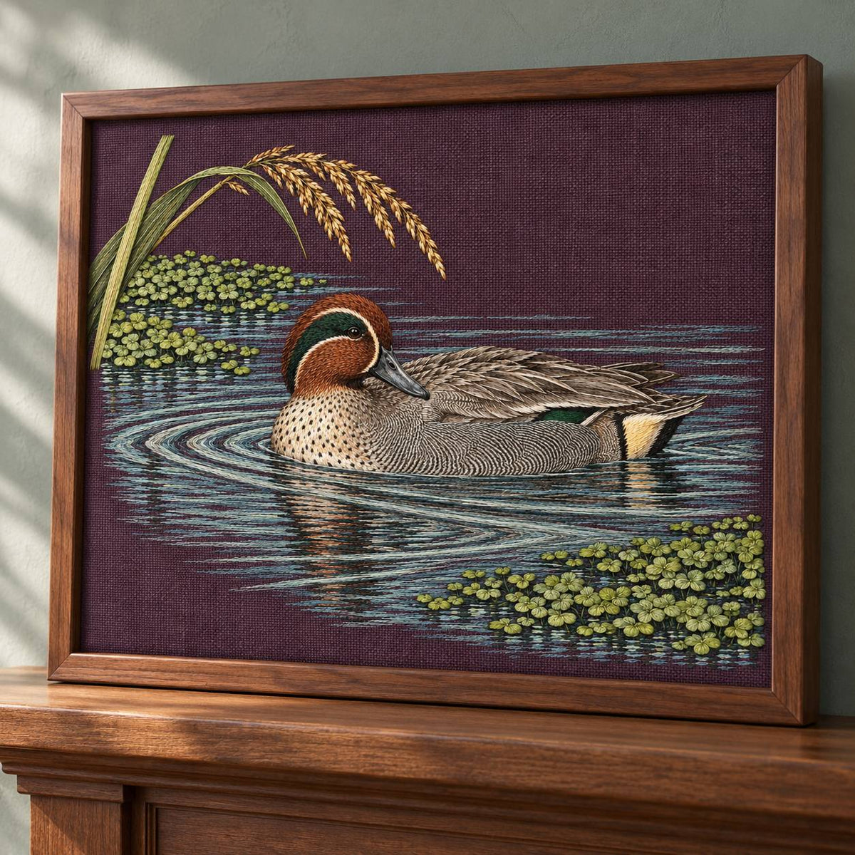 Teal at the Green Water Fold visual mockup shown in a frame leaning on a mantel, with the design on deep plum linen.