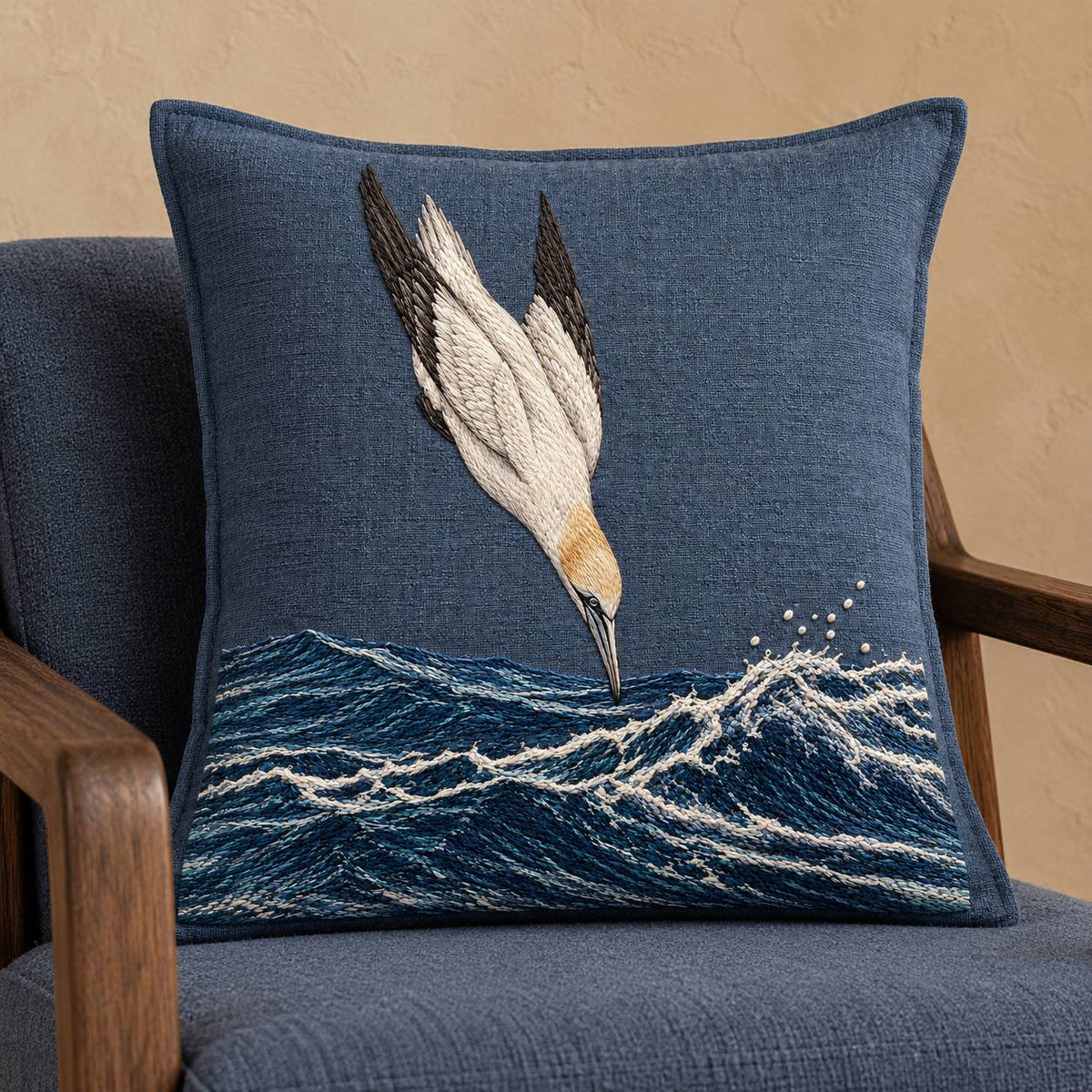 Gannet in the Whitewater Plunge visual mockup shown on a cushion in a lounge chair, with the design on slate-blue linen.
