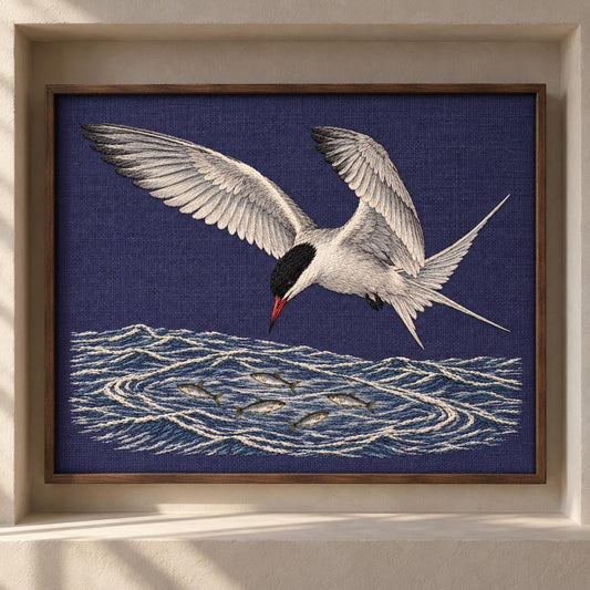 Common Tern Above the Silver Shoal visual mockup shown as a framed textile in a gallery niche, with the design on deep blue-violet linen.