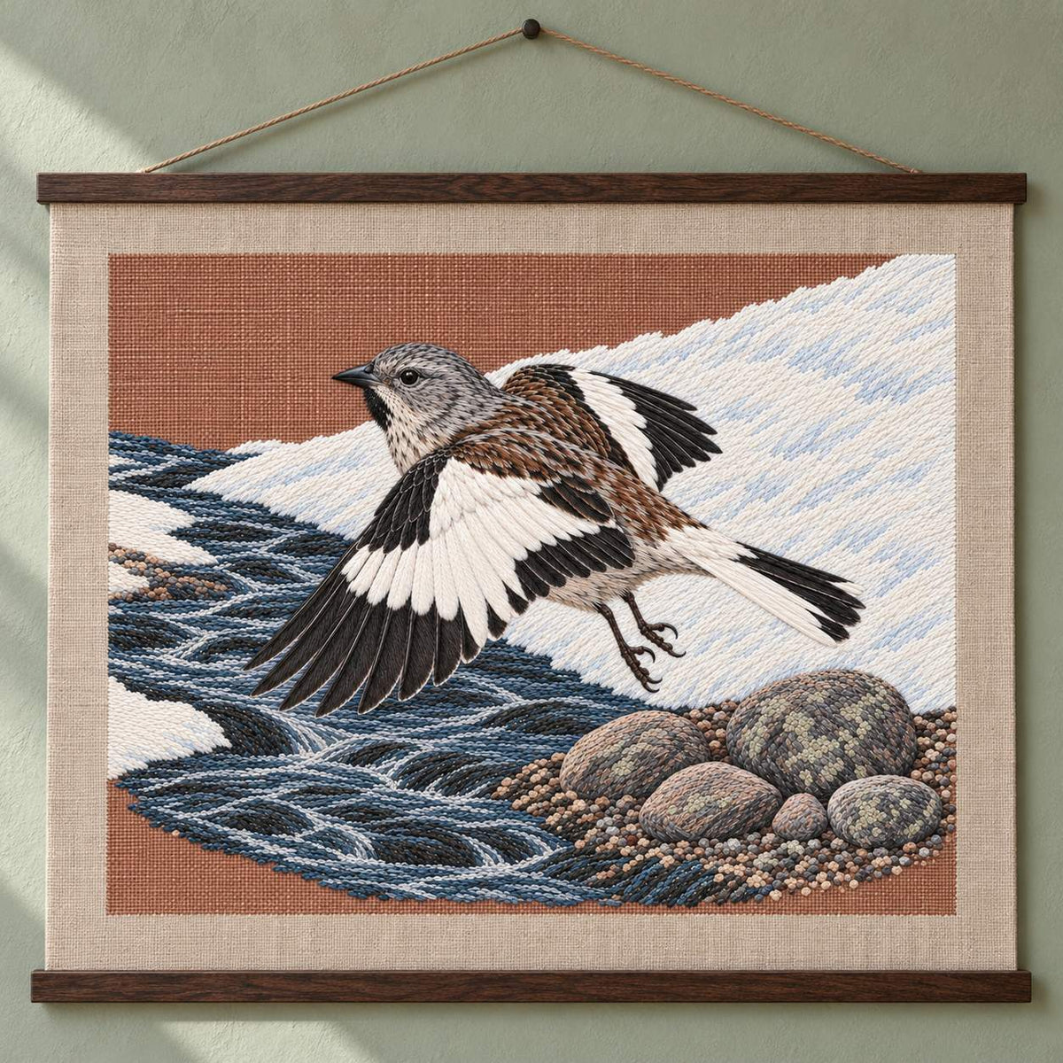 Snowfinch Along the Meltwater Cut visual mockup shown as a hanging textile held by wooden rails, with the design on warm oatmeal linen.