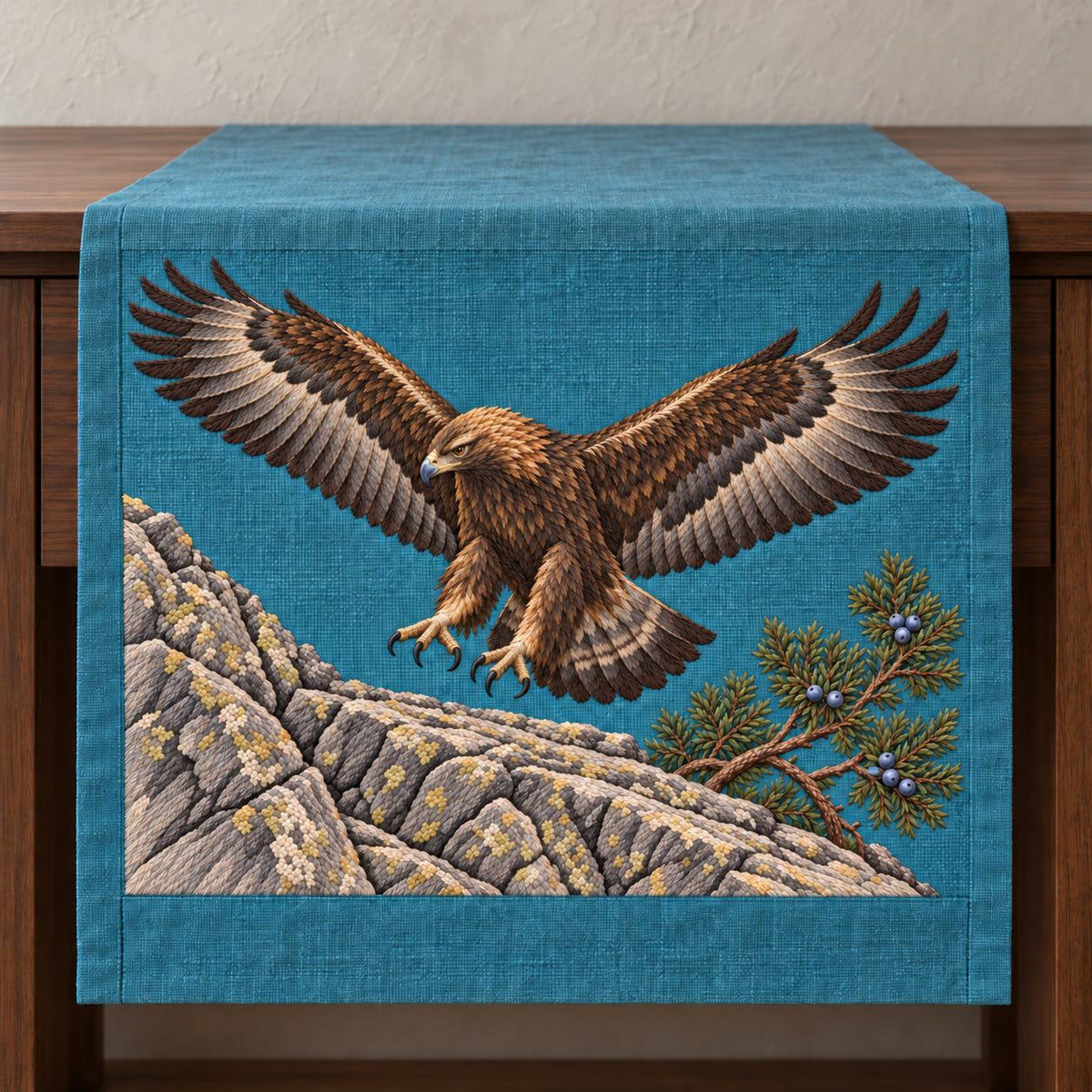 Golden Eagle Above the Juniper Shelf visual mockup shown on a textile runner over a console, with the design on teal-blue linen.