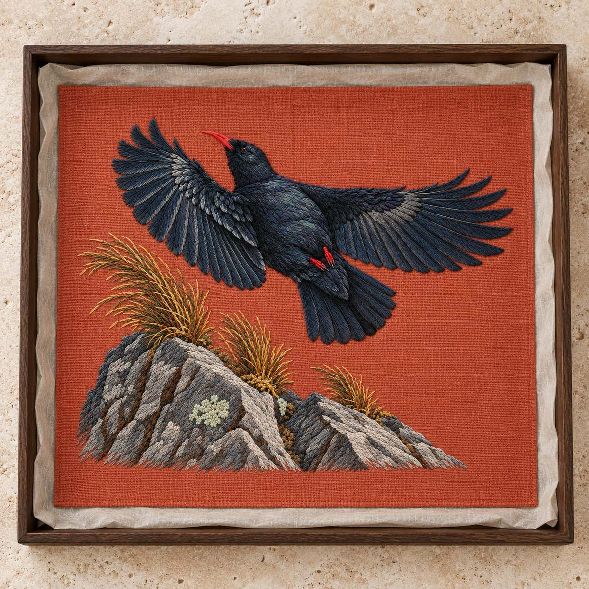 Chough at the Red Summit Flag visual mockup shown as a textile panel in a collection tray, with the design on muted rust linen.