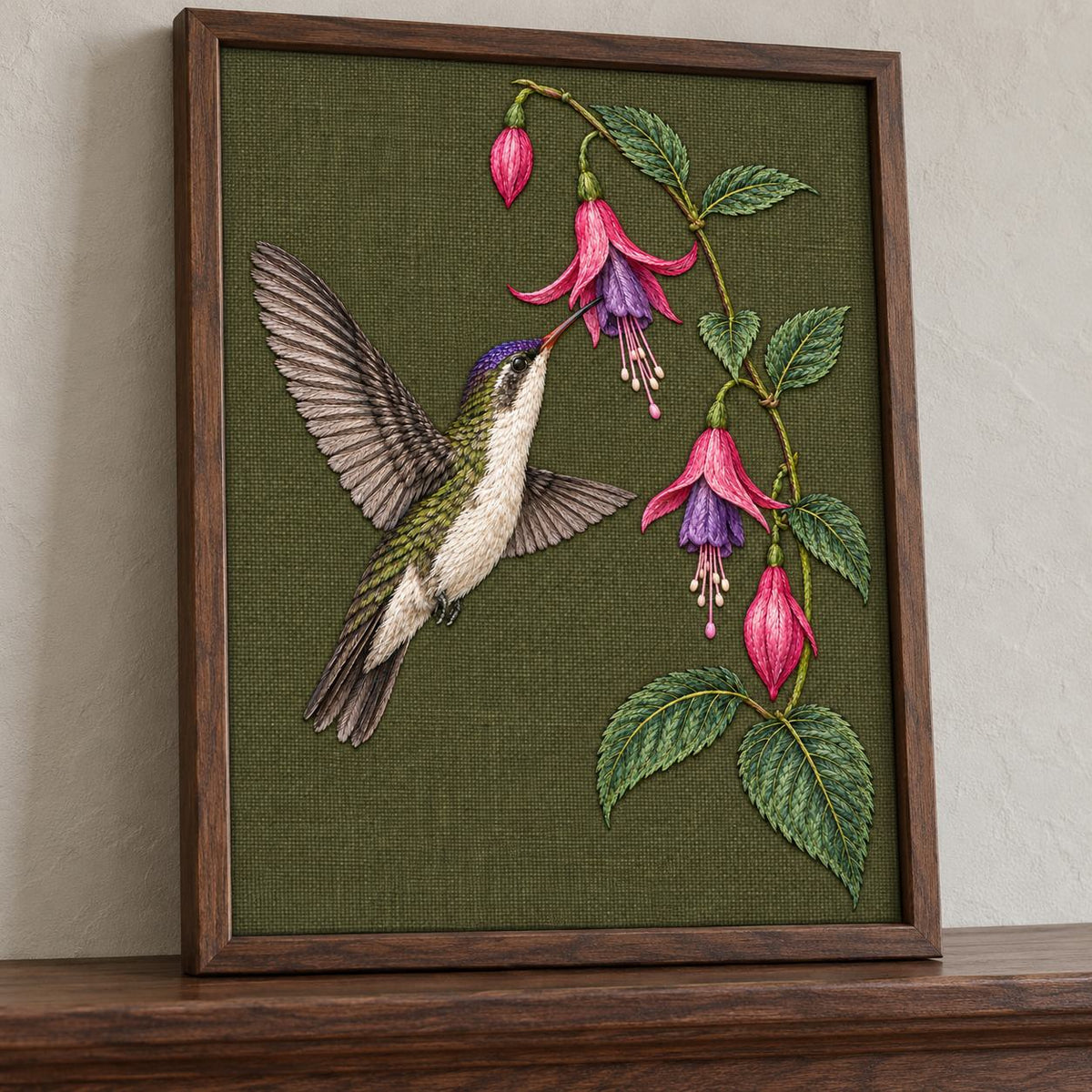Violet Crown at the Fuchsia Cascade visual mockup shown in a frame leaning on a mantel, with the design on dark olive linen.