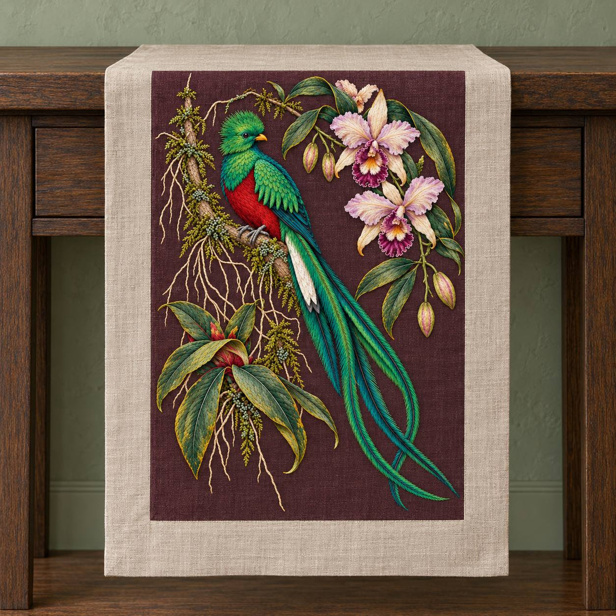 Quetzal Through the Orchid Arch visual mockup shown on a textile runner over a console, with the design on deep burgundy-plum linen.