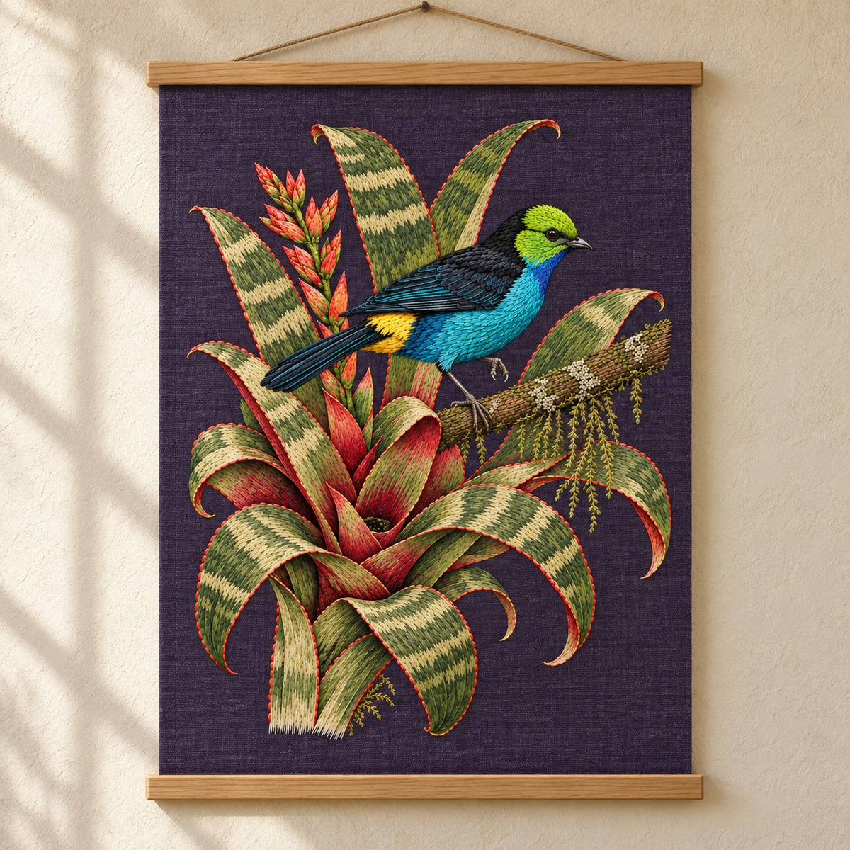 Paradise Tanager in the Bromeliad Wheel visual mockup shown as a hanging textile held by wooden rails, with the design on deep violet-slate linen.