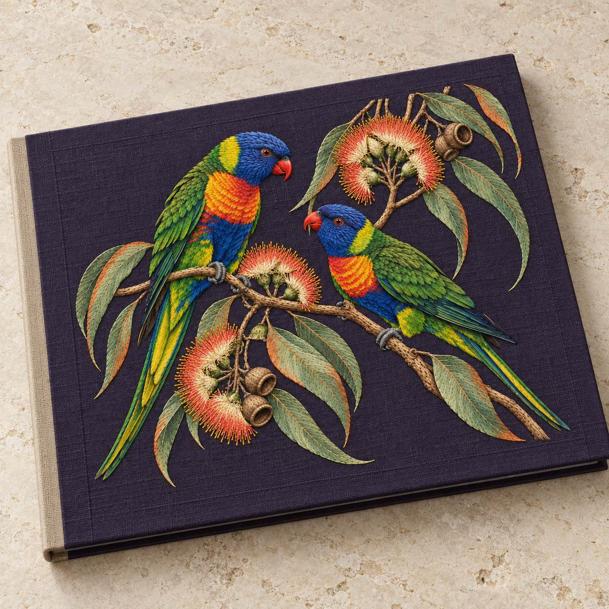 Lorikeet Across the Eucalyptus Fire visual mockup shown on a cloth portfolio cover, with the design on deep violet linen.