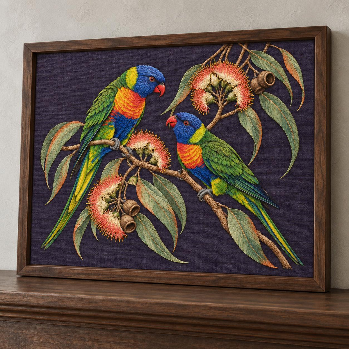 Lorikeet Across the Eucalyptus Fire visual mockup shown in a frame leaning on a mantel, with the design on deep violet linen.