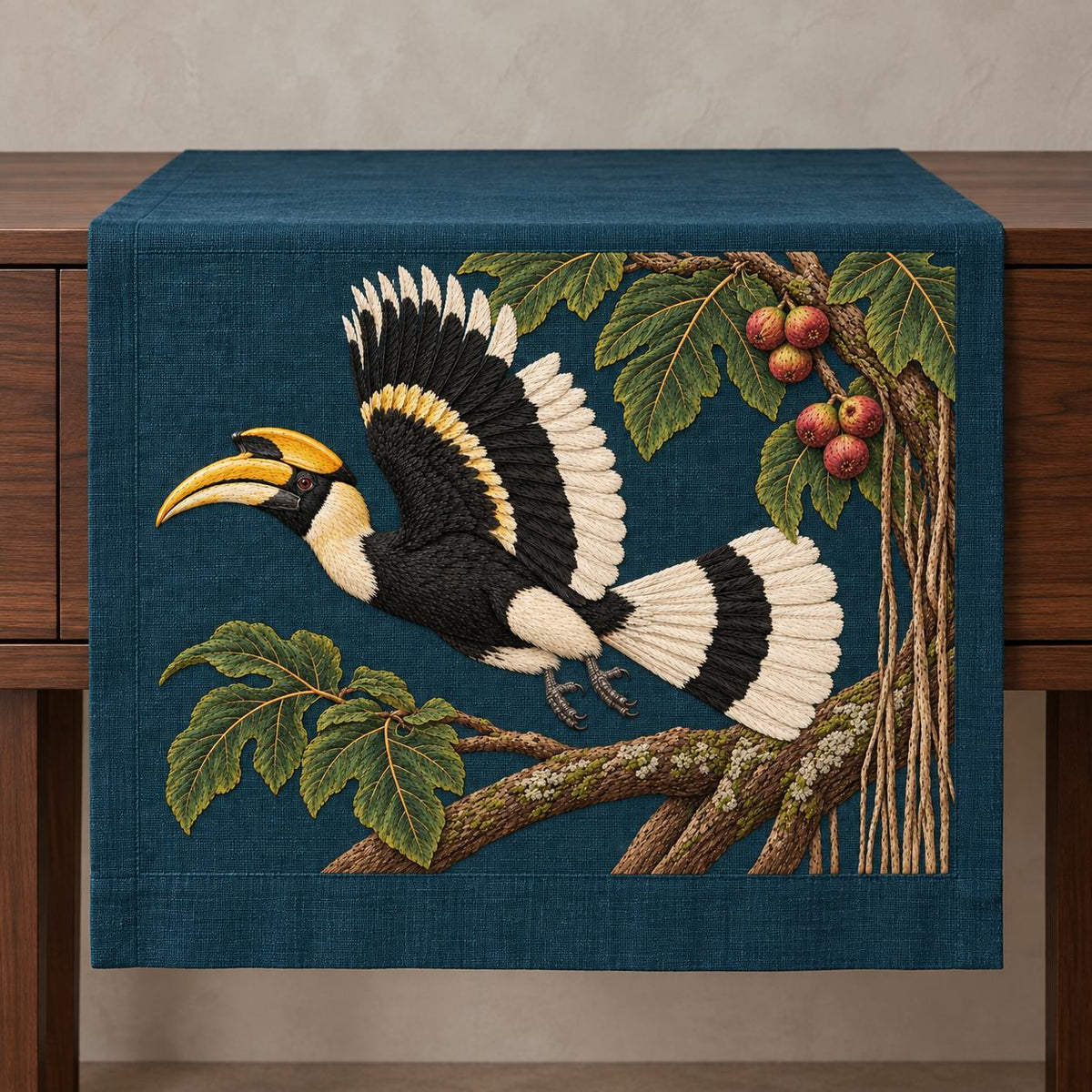 Hornbill Above the Fig Vault visual mockup shown on a textile runner over a console, with the design on deep teal-blue linen.