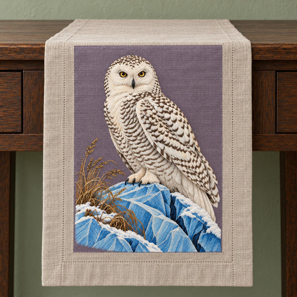 Snowy Owl on the Blue Ice Ridge visual mockup shown on a textile runner over a console, with the design on muted lavender-grey linen.