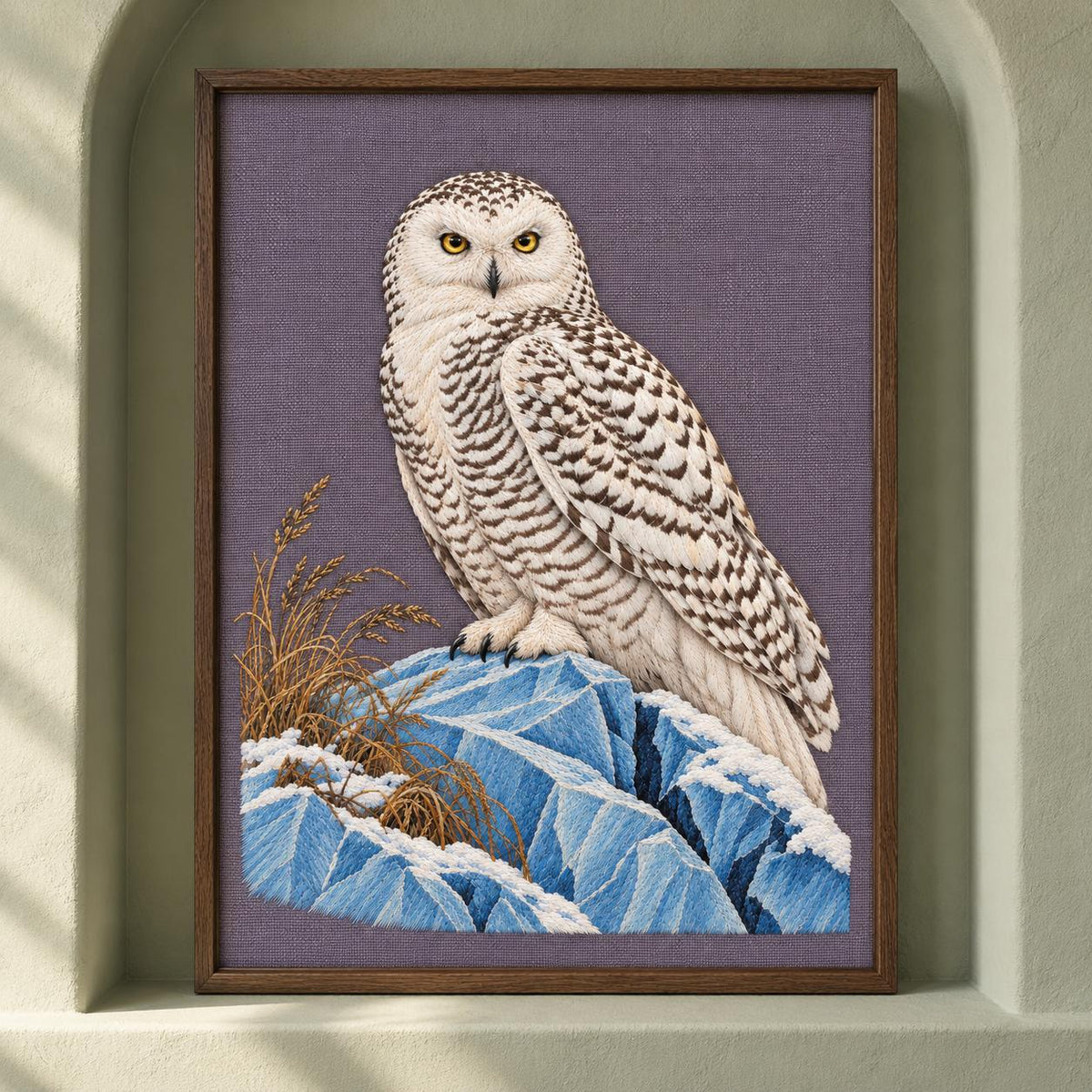 Snowy Owl on the Blue Ice Ridge visual mockup shown as a framed textile in a gallery niche, with the design on muted lavender-grey linen.