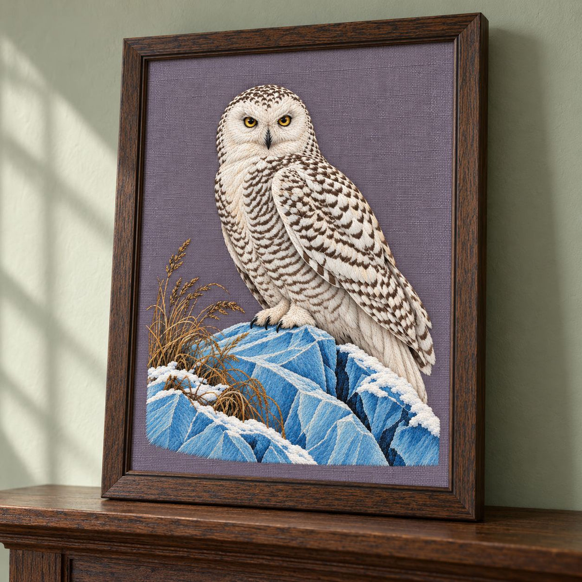 Snowy Owl on the Blue Ice Ridge visual mockup shown in a frame leaning on a mantel, with the design on muted lavender-grey linen.