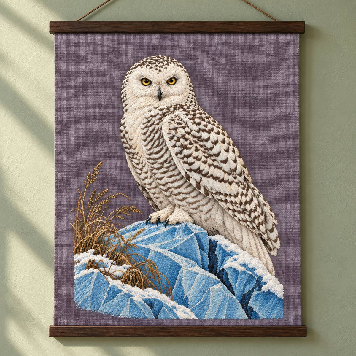 Snowy Owl on the Blue Ice Ridge visual mockup shown as a hanging textile held by wooden rails, with the design on muted lavender-grey linen.