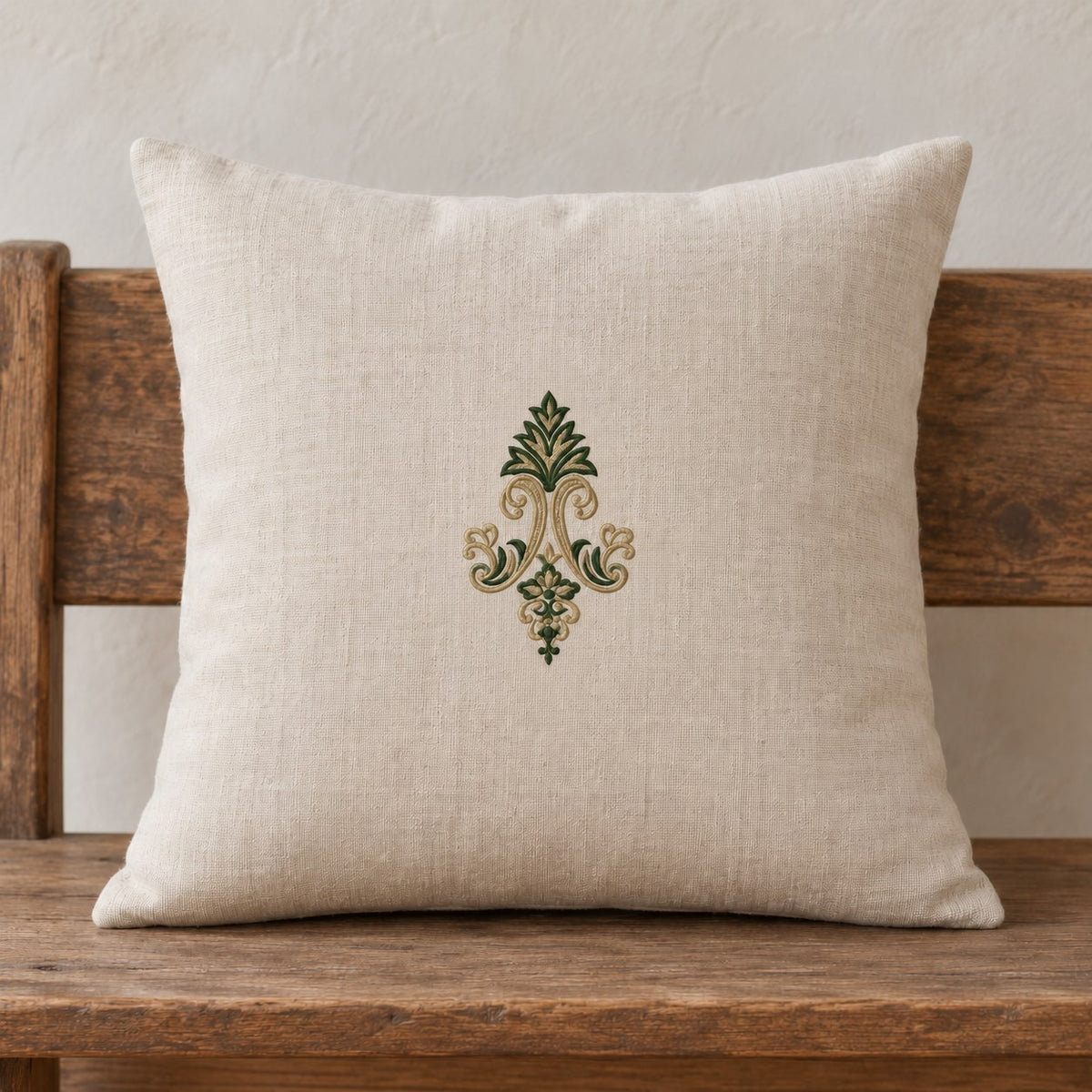 Acanthus Crown Floral Drop embroidered in parchment and forest green on a linen cushion, showing the complete two-color motif.