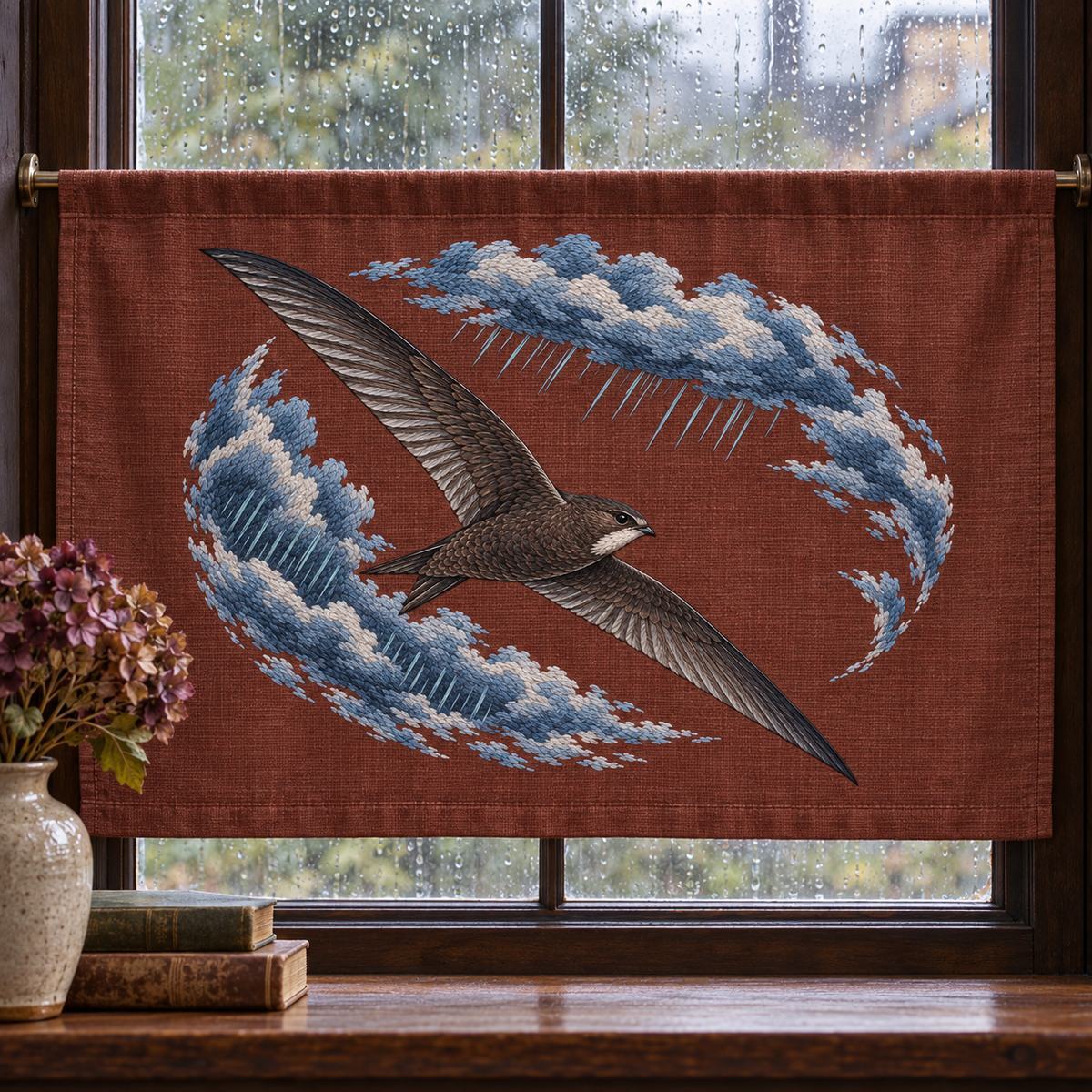 Swift embroidery design in a digital mockup of horizontal embroidered lower blind panel on a broad rainy studio window. Placement inspiration for Study 02.