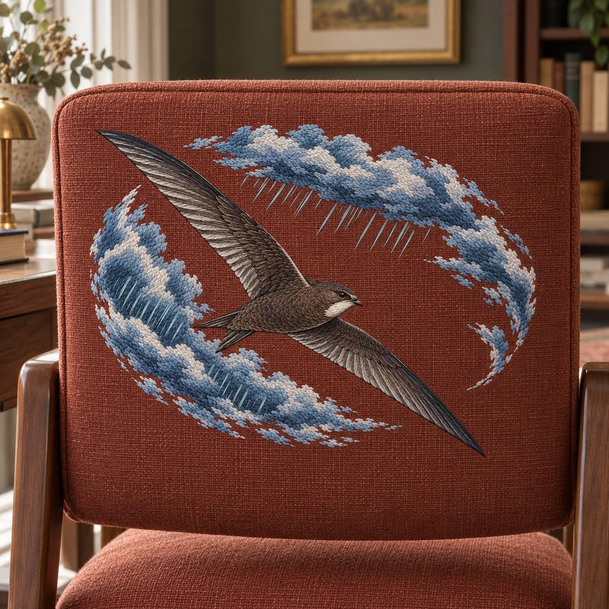 Swift embroidery design in a digital mockup of rectangular rust upholstered desk-chair back, embroidery facing camera. Placement inspiration for Study 02.