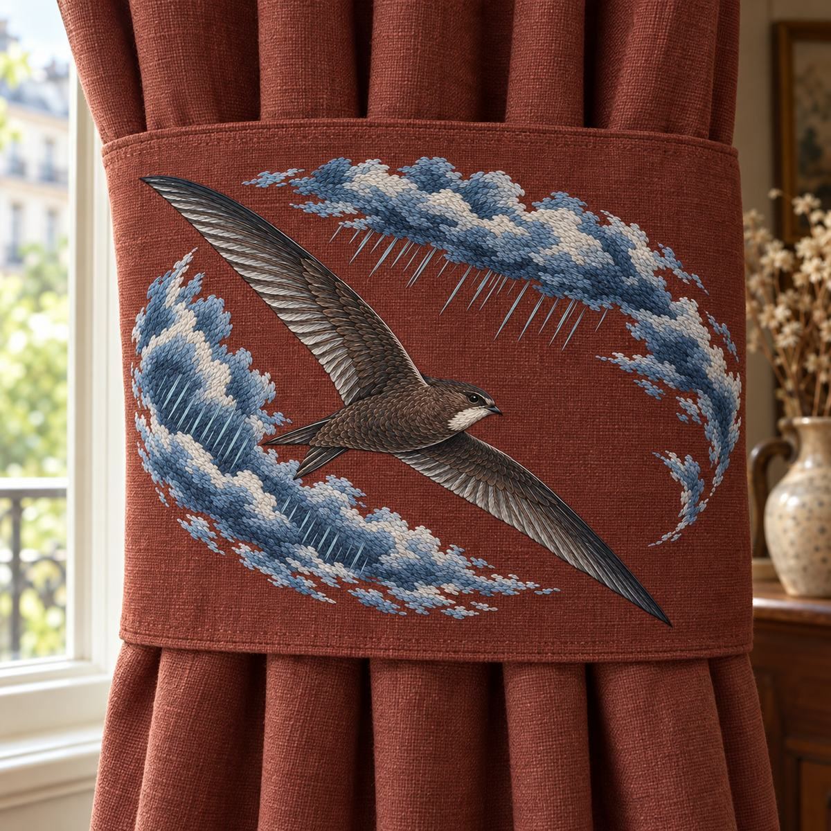 Swift embroidery design in a digital mockup of landscape embroidery on broad café window curtain tie-panel laid flat against curtain, not folded. Placement inspiration for Study 02.