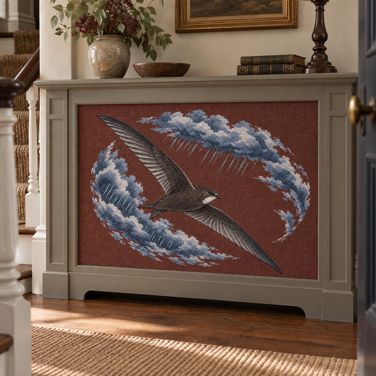 Swift embroidery design in a digital mockup of wide rust fabric radiator screen inset, traditional townhouse hallway. Placement inspiration for Study 02.