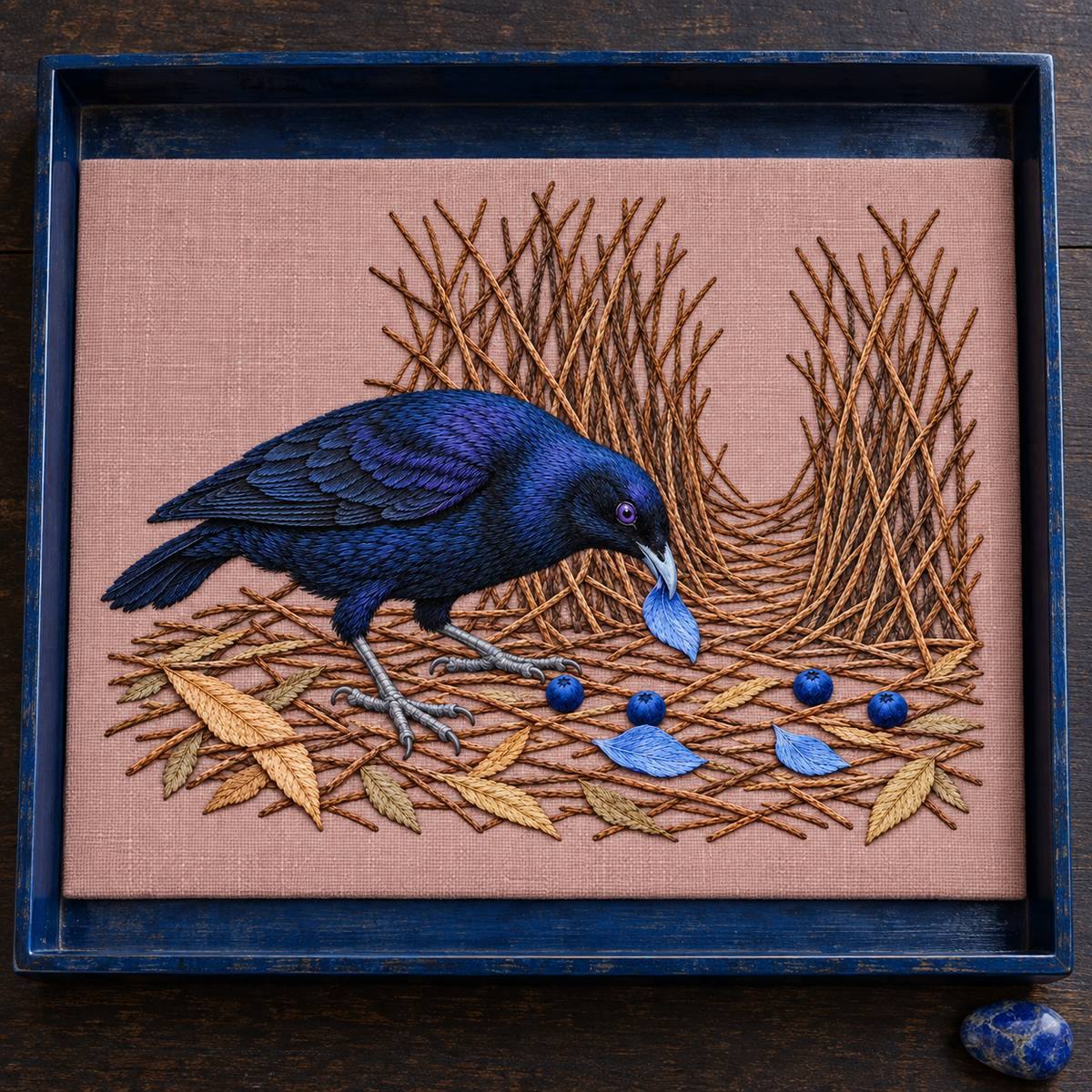 Satin Bowerbird hand embroidery design on a dark blue wall frame. Digital placement mockup; finished item and materials are not included.