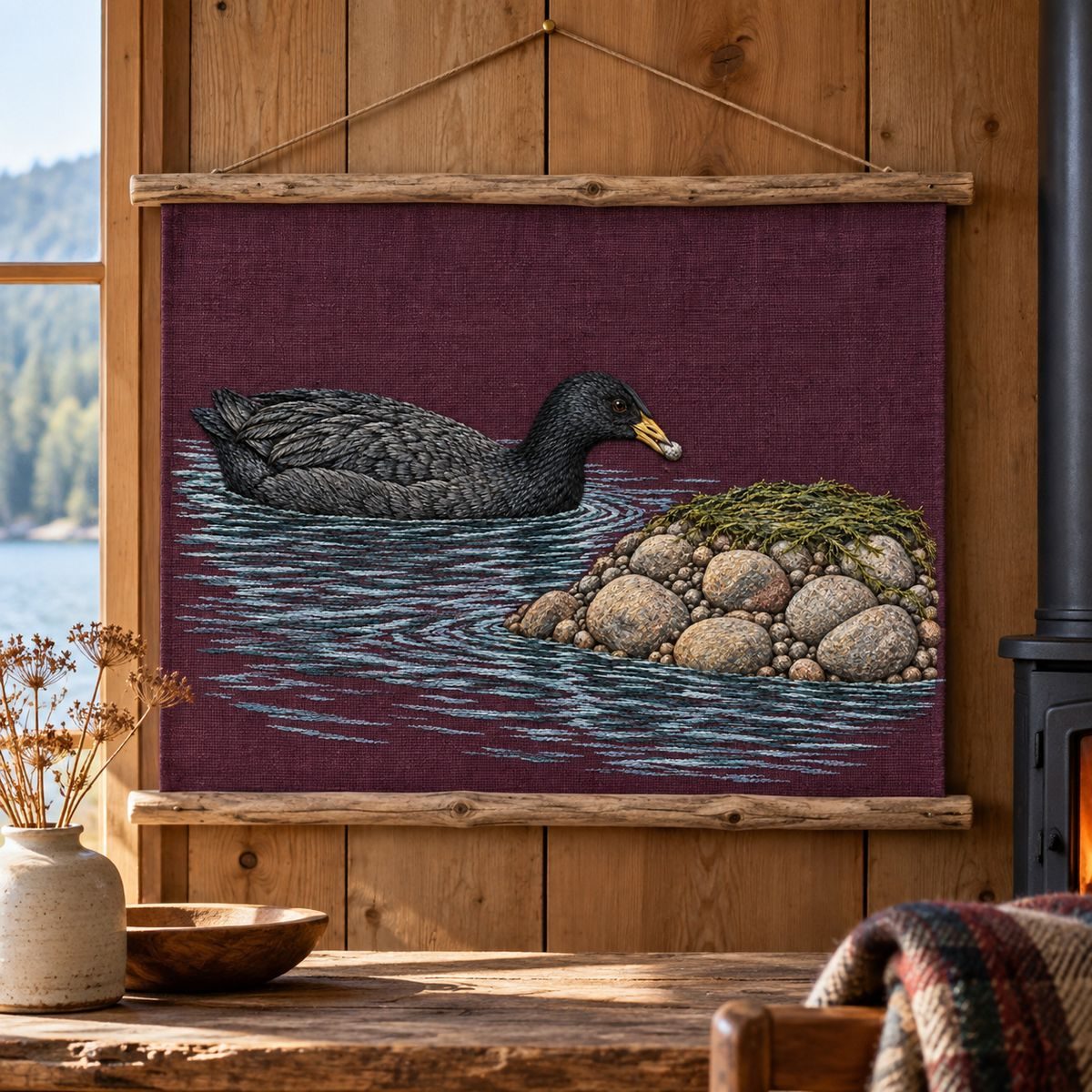 Coot embroidery design in a digital mockup of A landscape textile banner fixed flat between two slim driftwood rails inside a quiet cabin. Placement inspiration for Study 25.
