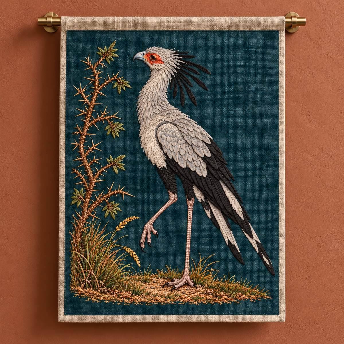 Secretarybird embroidery design in a digital mockup of Portrait linen panel suspended from a brushed-brass rail against a muted clay wall. Full motif , broad empty wall just around object. Placement inspiration for Study 45.