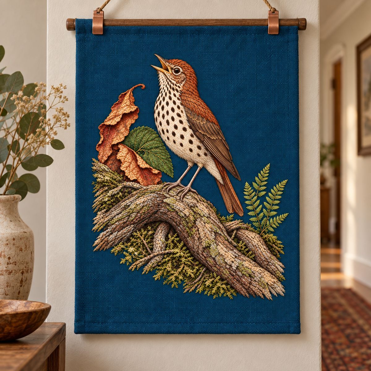 Wood Thrush embroidery design in a digital mockup of A hanging portrait fabric art panel in a quiet hallway, slim copperclips above motif. Placement inspiration for Study 55.