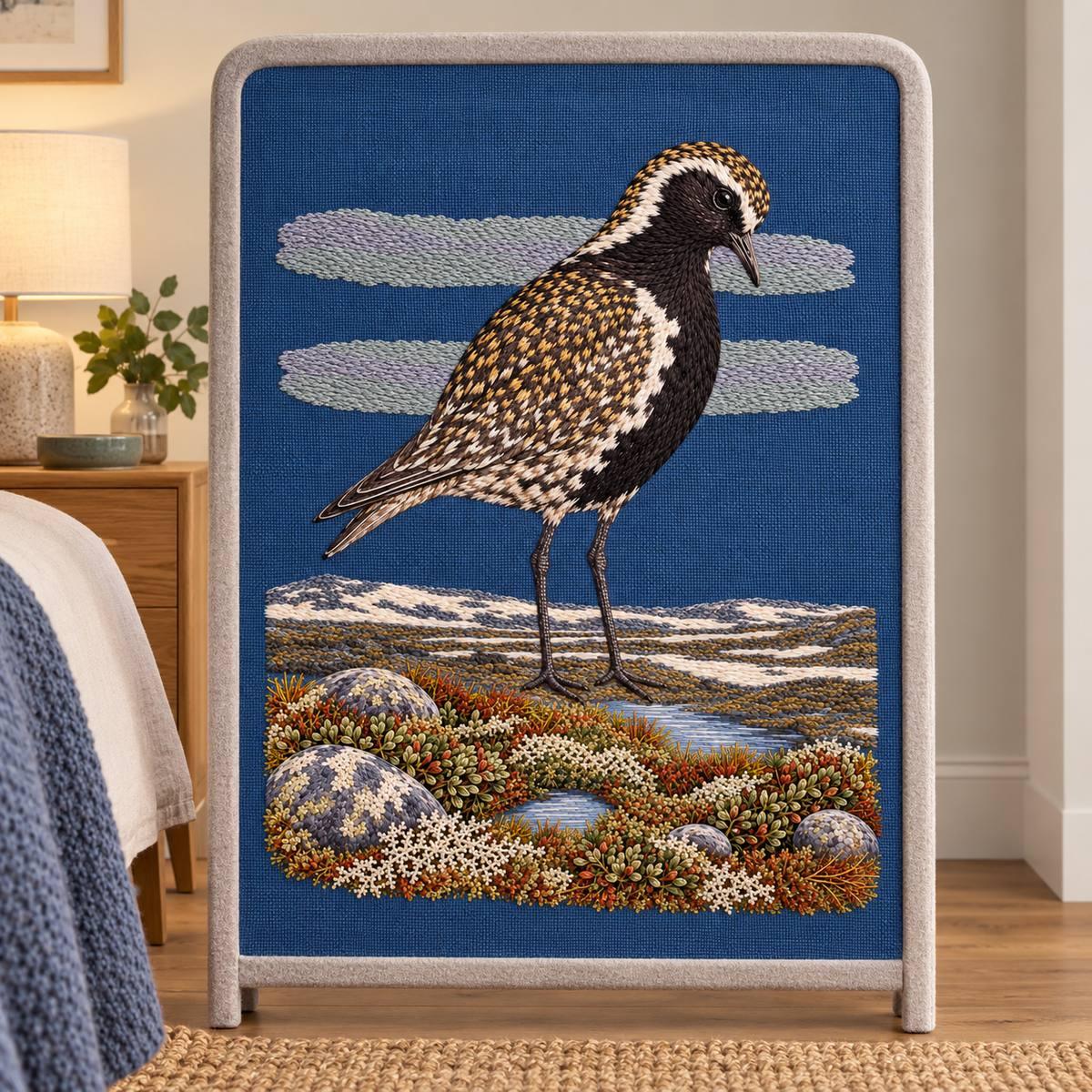 Golden Plover embroidery design in a digital mockup of A storm-blue embroidered panel on a wool bedside screen, single tall freestanding frame with pale felt surround. Placement inspiration for Study 68.
