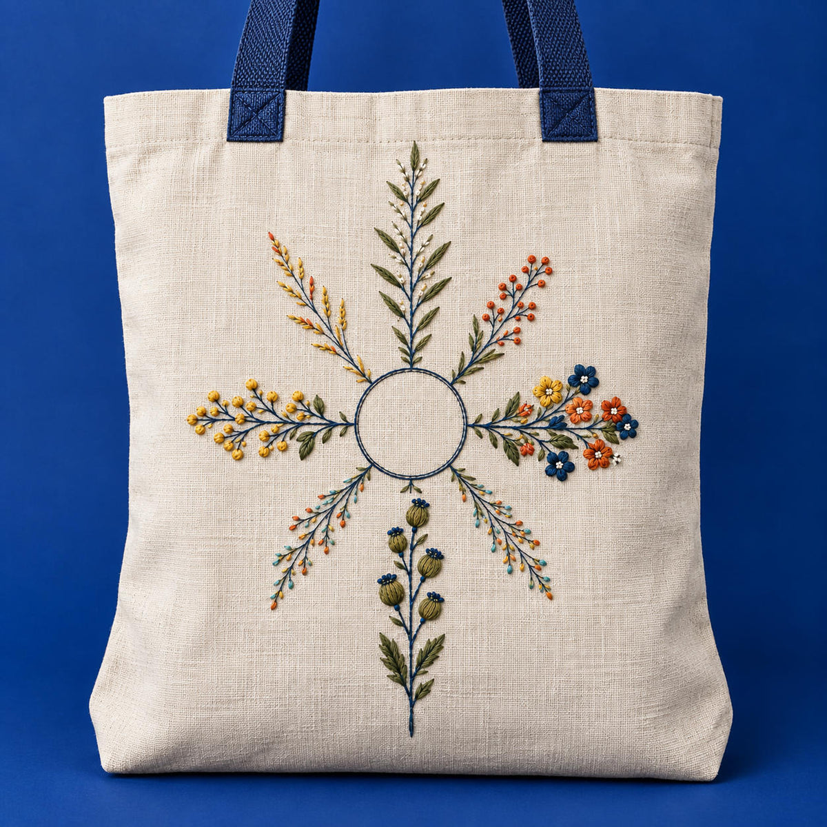 Linen tote bag mockup featuring the Botanical Compass Lines hand embroidery design. Eight unequal botanical arms surround an unfilled circle in Botanical Compass Lines.
