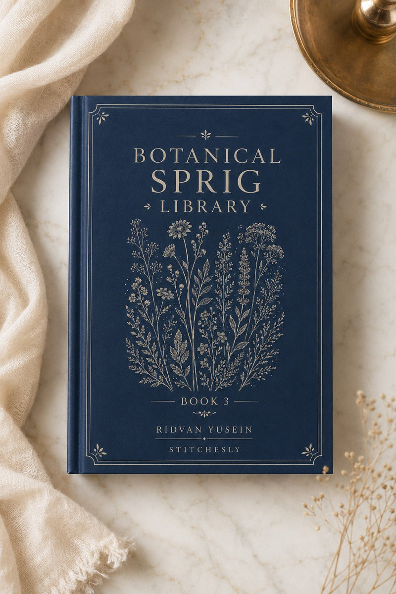 Botanical Sprig Library Book Three displayed flat beside flowers and linen.