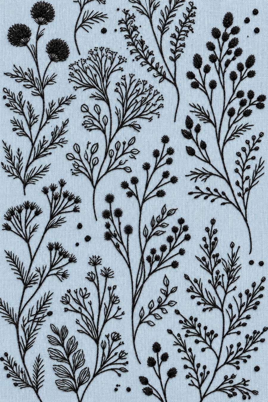 Hand embroidery of a cropped full-page arrangement of delicate thistle-like flower heads, branching seed stems, tiny buds and separate herb sprigs in charcoal and ivory cotton on soft pale powder blue linen.