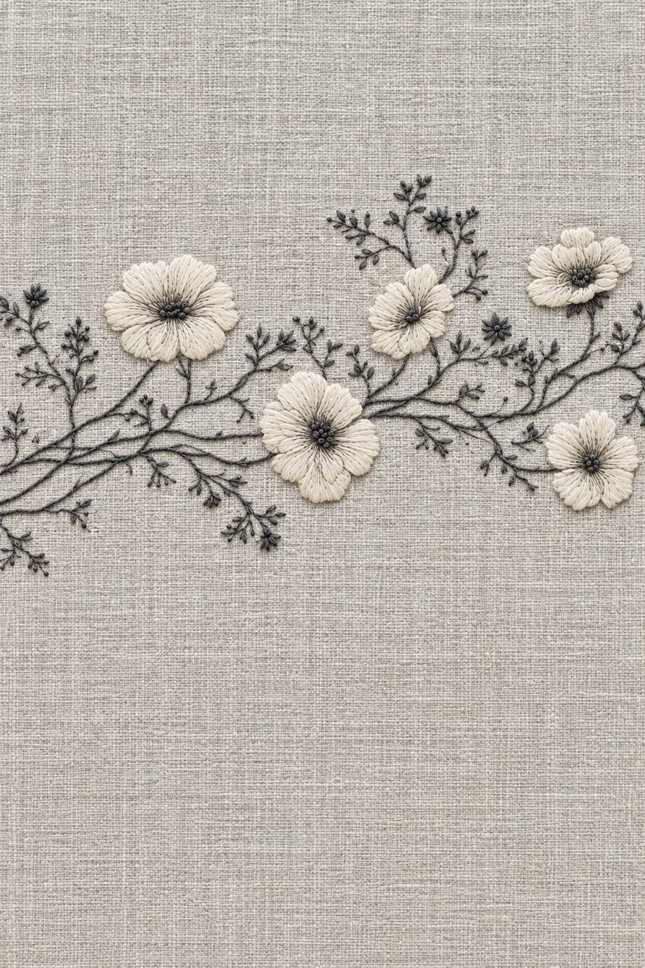 Five warm ivory flowers with fine charcoal branching stems and small buds in a horizontal border on pale stone-grey linen.