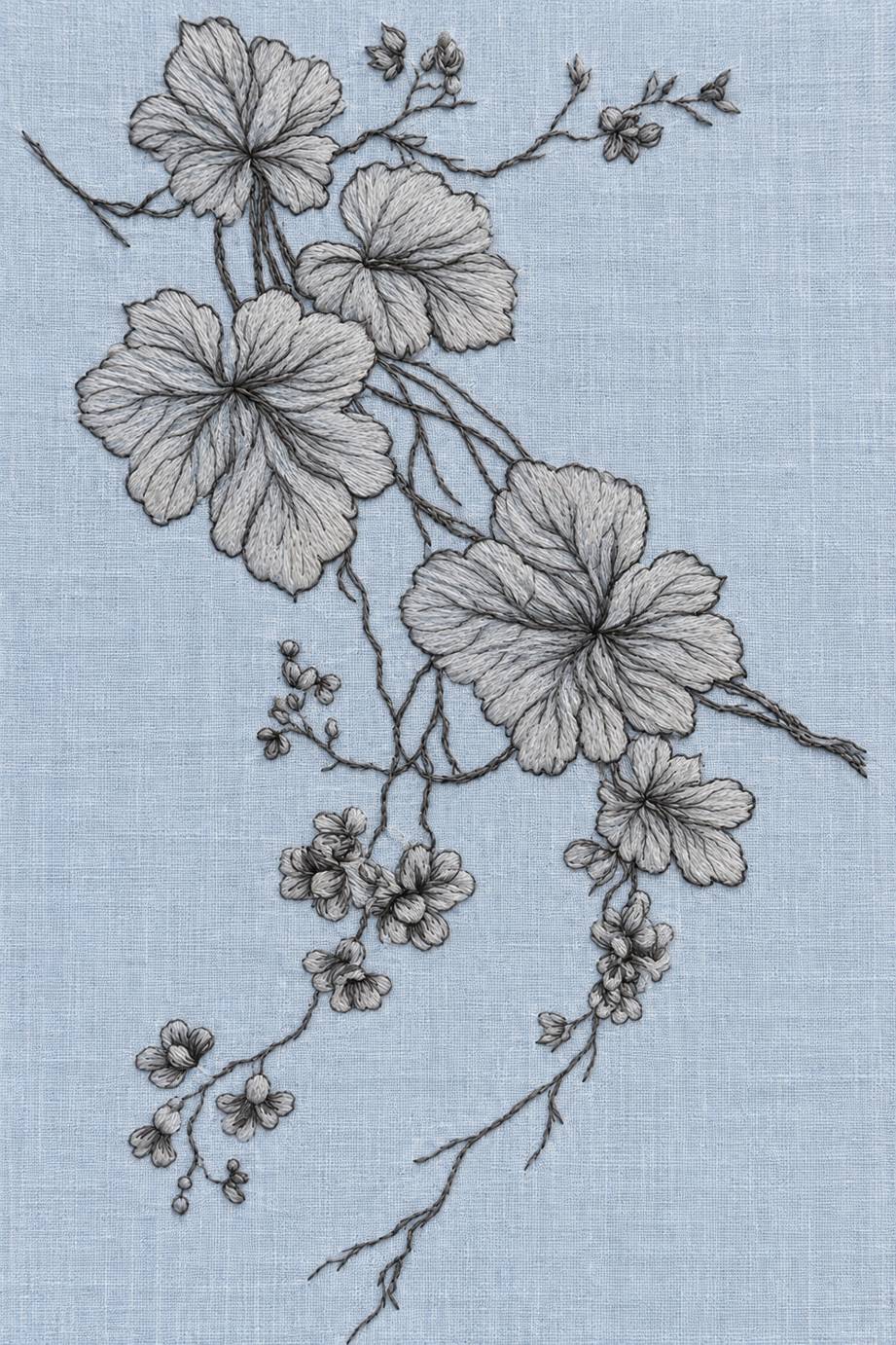 Fine cotton embroidery of diagonal large leaves and trailing blossoms on powder blue linen.