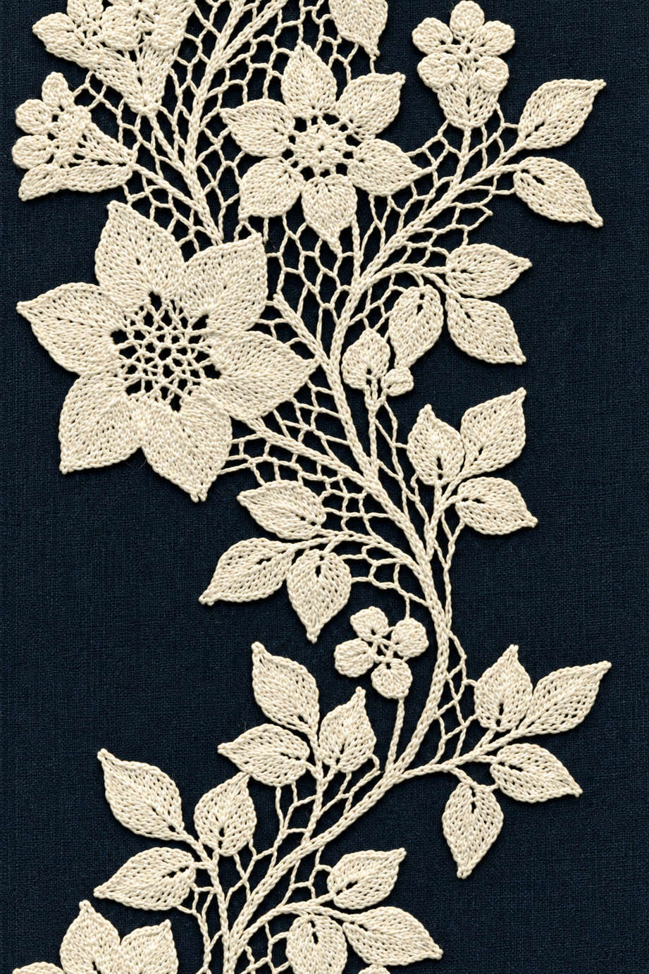 Fine cotton hand-worked lace and embroidery of large flower and leaf vine, from Crochet Lace Borders and Edgings Book Three.